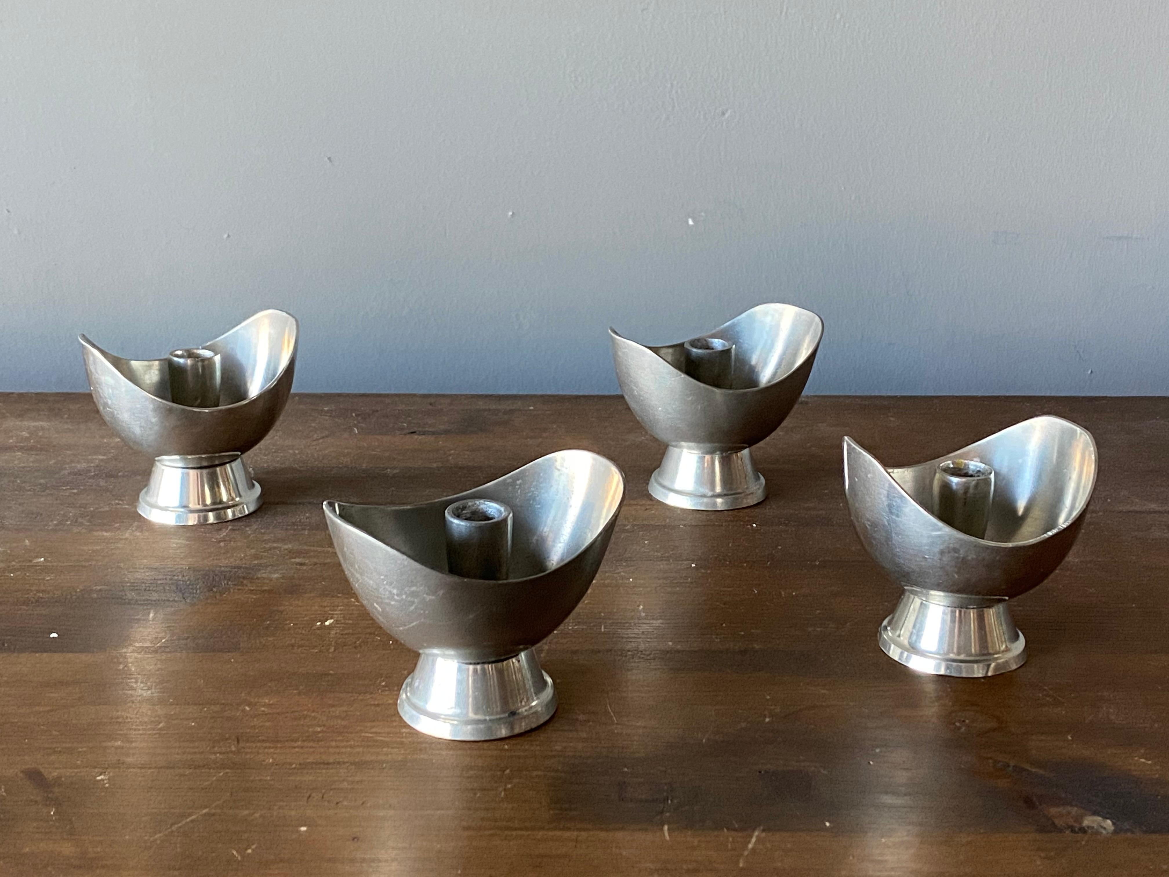 A set of modernist candlesticks. Designed and produced by GAB, Guldsmedsaktiebolaget, Sweden, 1930s. Marked. In Pewter. 

Two pairs, each pair of slightly different shape.



  