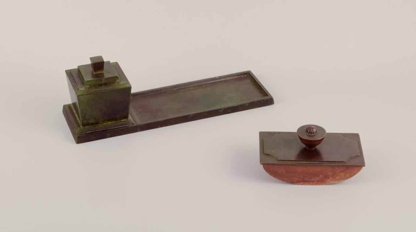 GAB, Sweden. Art Deco writing set in solid bronze. 
With inkwell, pen tray, and blotter.
Approximately 1930.
Beautiful patina.
Perfect condition.
Marked.
Dimensions: L 28.5 cm x H 10.0 cm.