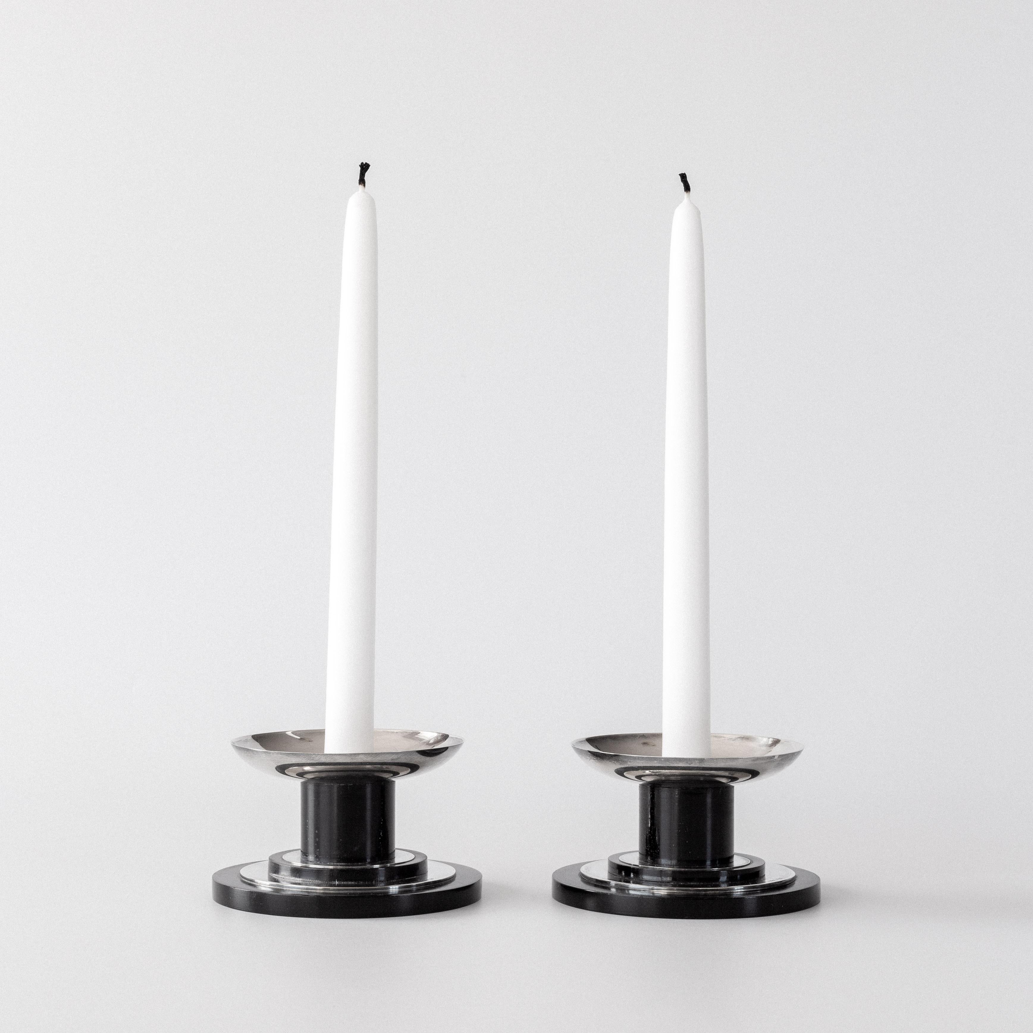 A beautiful pair of Swedish Modernist candlesticks from GAB (Guldsmedsaktiebolaget) of Sweden. Made in 1934 (confirmed by the H8 hallmark), these candlesticks showcase the clean geometric forms and material honesty characteristic of early Modernist