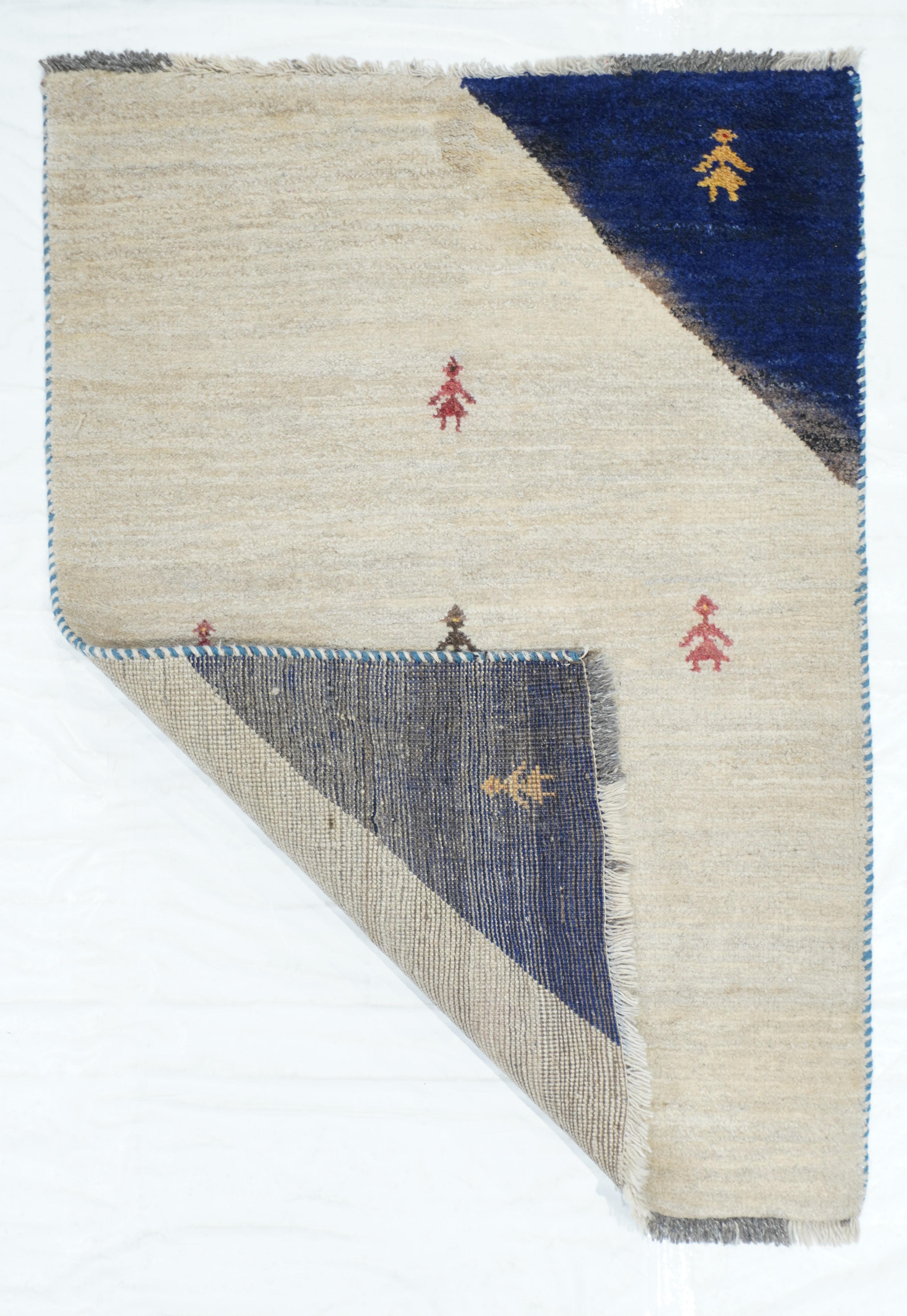 This bold SW Persian nomadic borderless scatter shows two opposing abrashed royal blue corners setting forth a natural ivory broad diagonal section. Seven female stick figures add to the rustic delight. Exceptional piece of abstract art, rustic or
