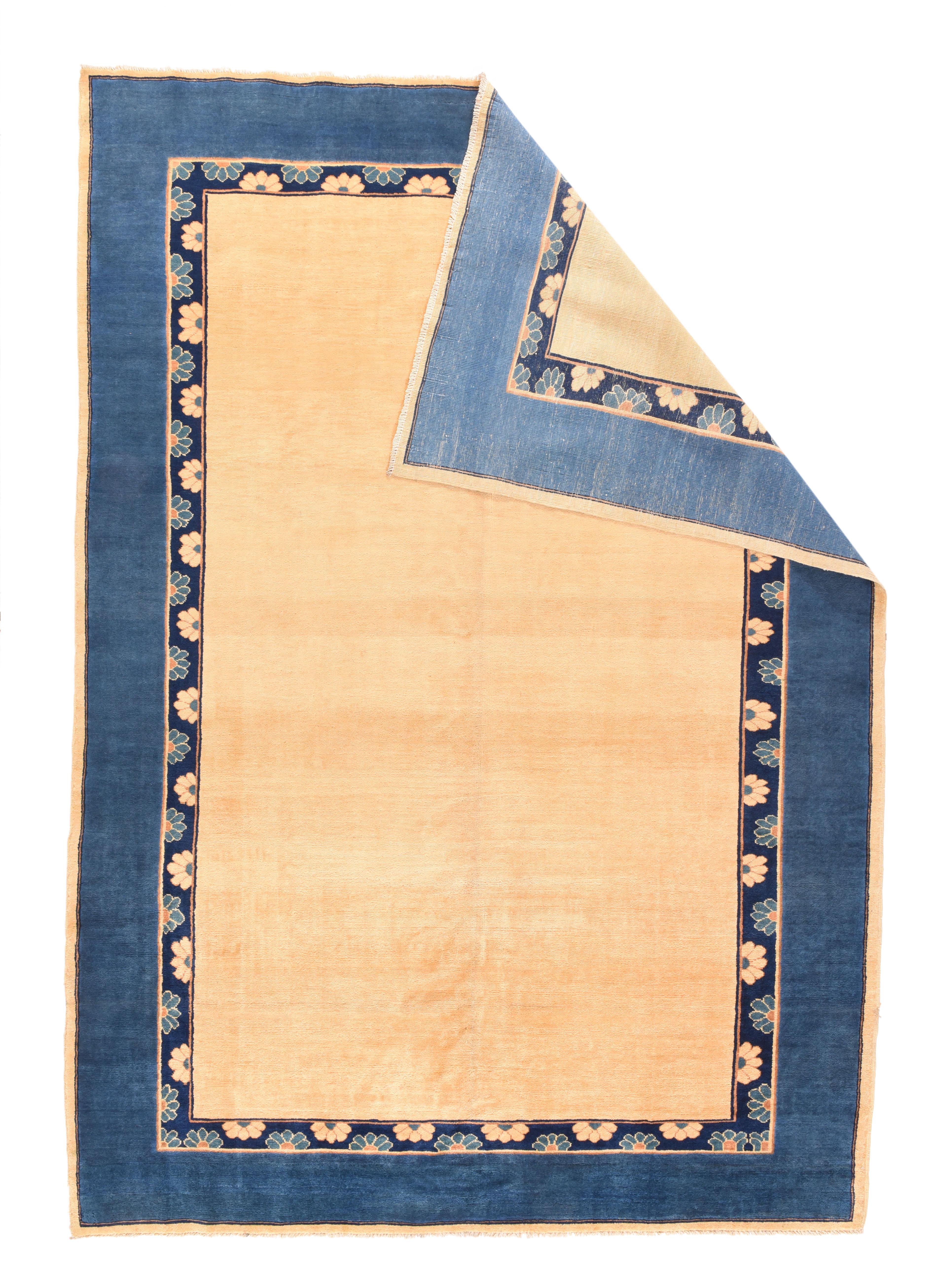 The straw open, plain field is framed by an inner navy border with half rosettes on the sides, and a wide plain blue main stripe, with a narrw straw outer minor finishing the layout. Iner border has a faintly Chinese look. Moderate/medium weave. As
