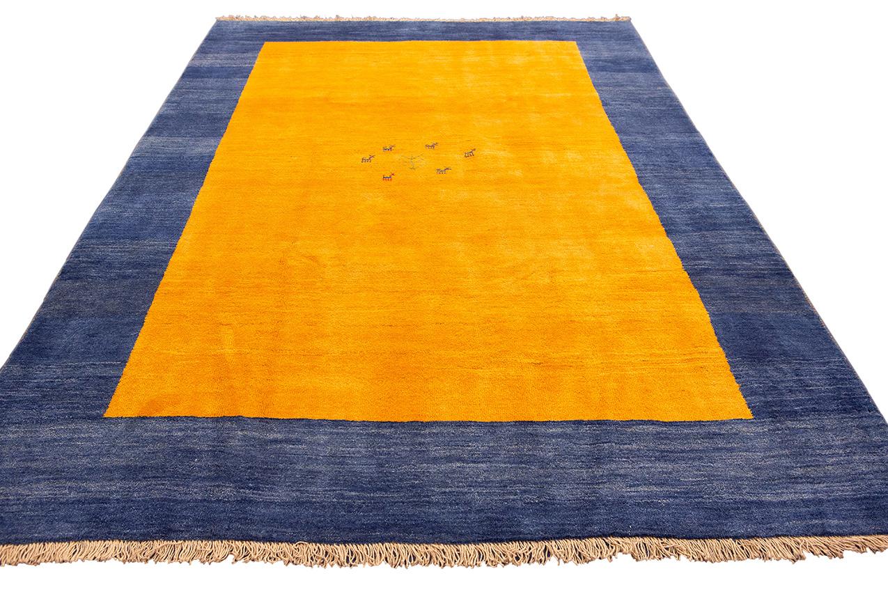 This is a timeless treasure, an amazing Gabbeh Rug Measuring 285×200 cm, this exquisite rug is a testament to 
artistry and tradition. The rug features a captivating design with a sunny yellow field that exudes warmth and cheerfulness. Its vibrant