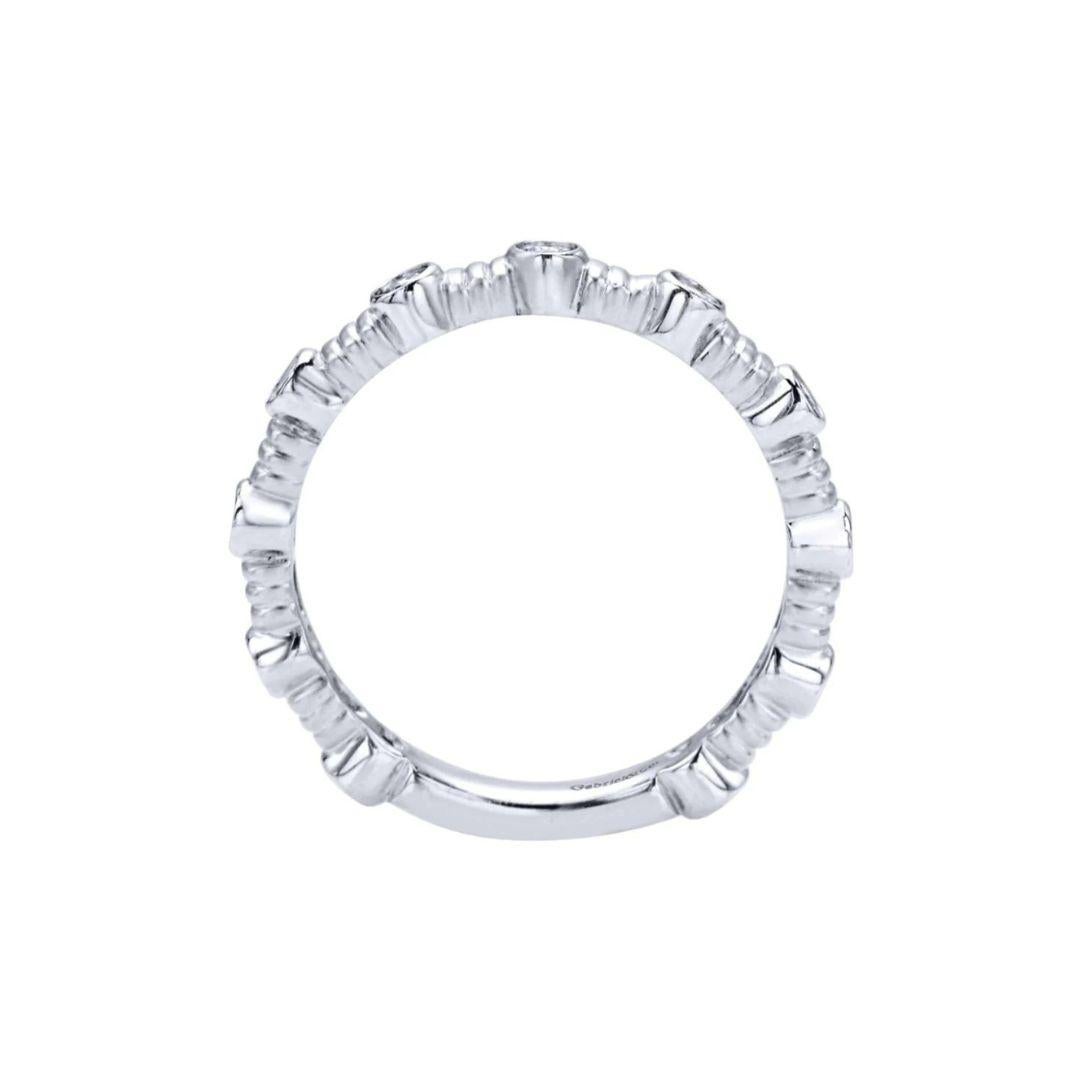 Contemporary textured band with bezel set diamonds in 14k white gold. Band contains 0.30 ctw of fine white round diamonds, H color, SI clarity. Band is suitable as a fashion ring, anniversary ring, a wedding band or a stackable ring.

 