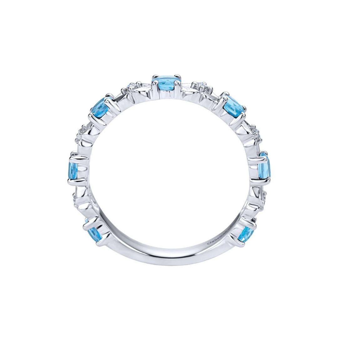 Sky blue topaz alternates with stunning white diamonds. Band contains 0.84 carats of fine blue topaz and 0.08 ctw of white round diamonds, H color, SI clarity. Band is suitable as a fashion ring, anniversary ring, a wedding band or a stackable ring.