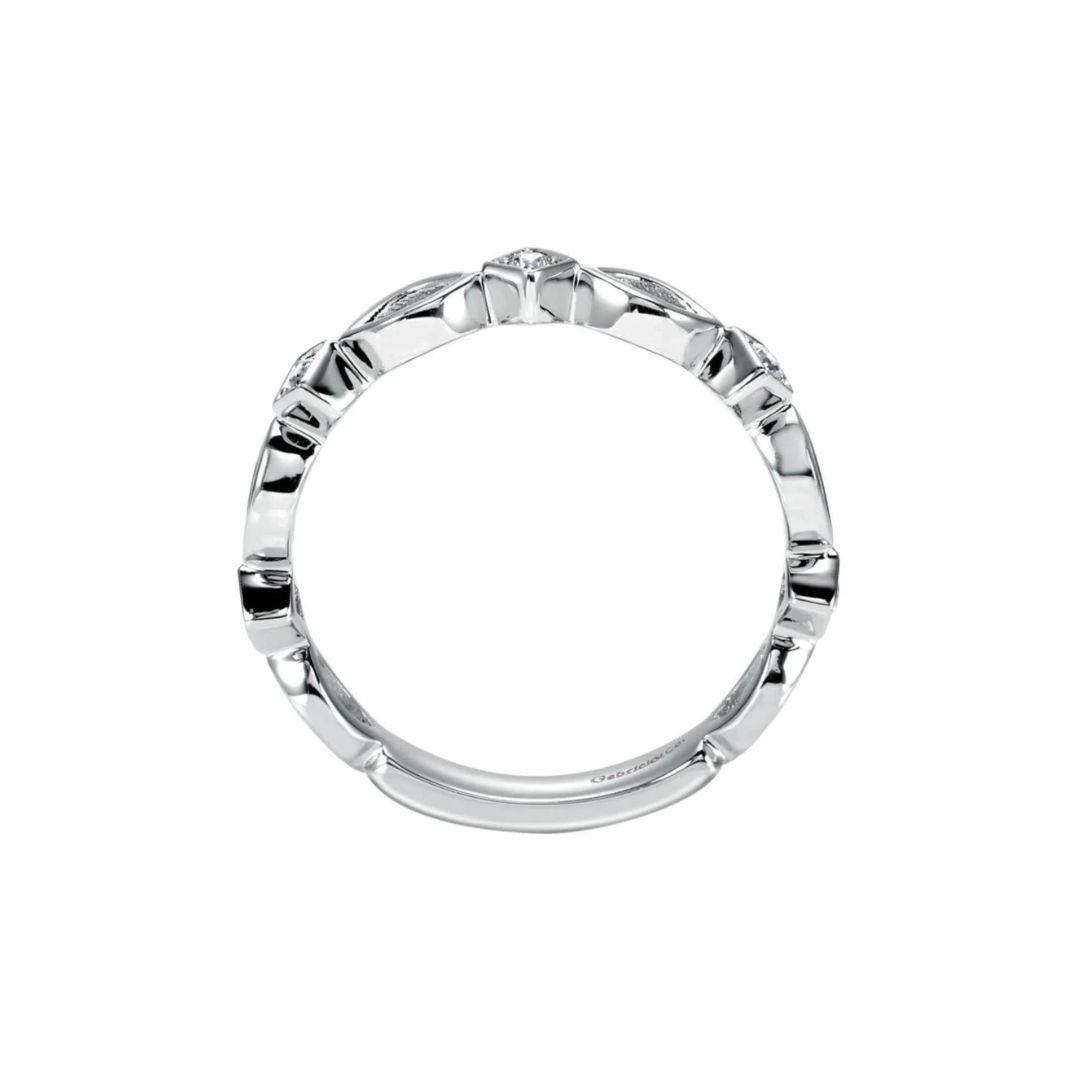 Delicate scalloped weave is offset with bead set white diamonds for an airy, romantic look. Band contains 0.08 ctw of fine white round diamonds, H color, SI clarity. Band is suitable as a fashion ring, anniversary ring, a wedding band or a stackable