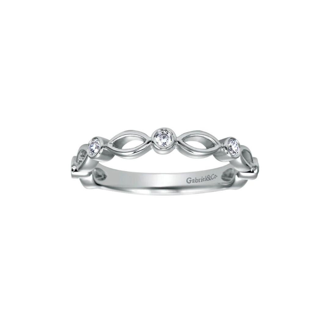 Delicate scalloped weave is offset with bezel set round white diamonds for an airy, romantic look. Band contains 0.33 ctw of fine white round diamonds, H color, SI clarity set in 14k white gold. Band is suitable as a fashion ring, anniversary ring,