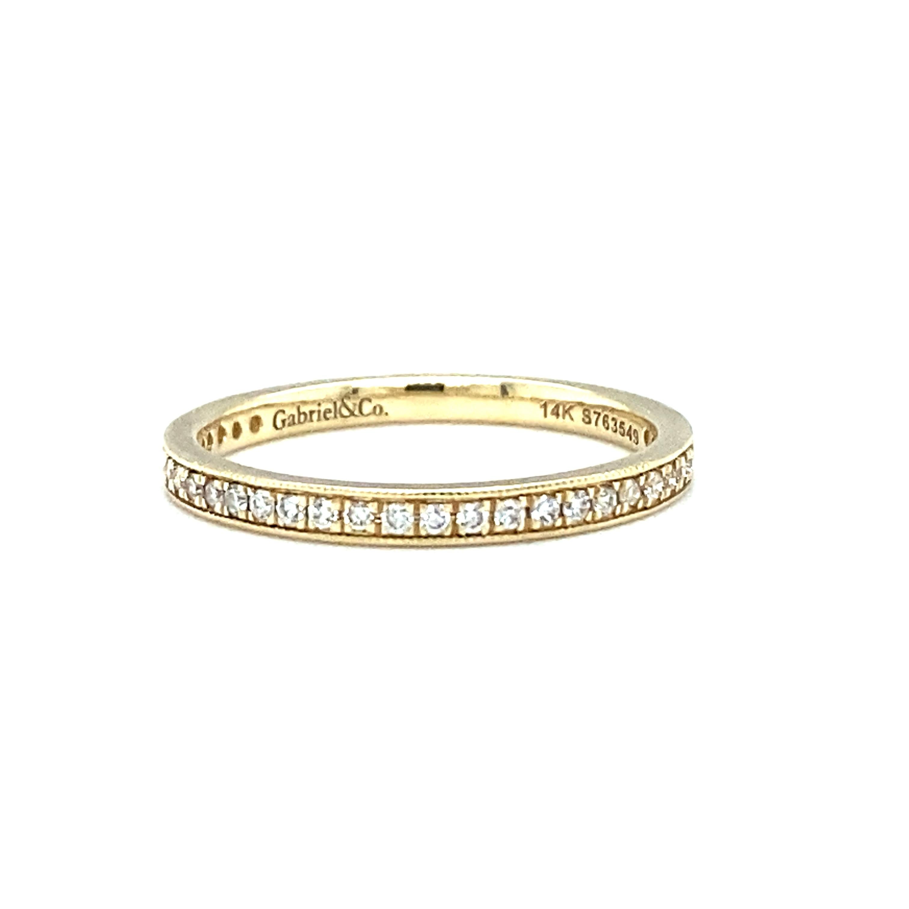 Item Details: This band by Gabriel & Co. has diamonds around almost all of the band, with an empty space making it able to be size adjusted.

Circa: 2000s
Metal Type: 14k yellow gold
Weight: 1 gram
Size: US 4, slightly resizable

Diamond