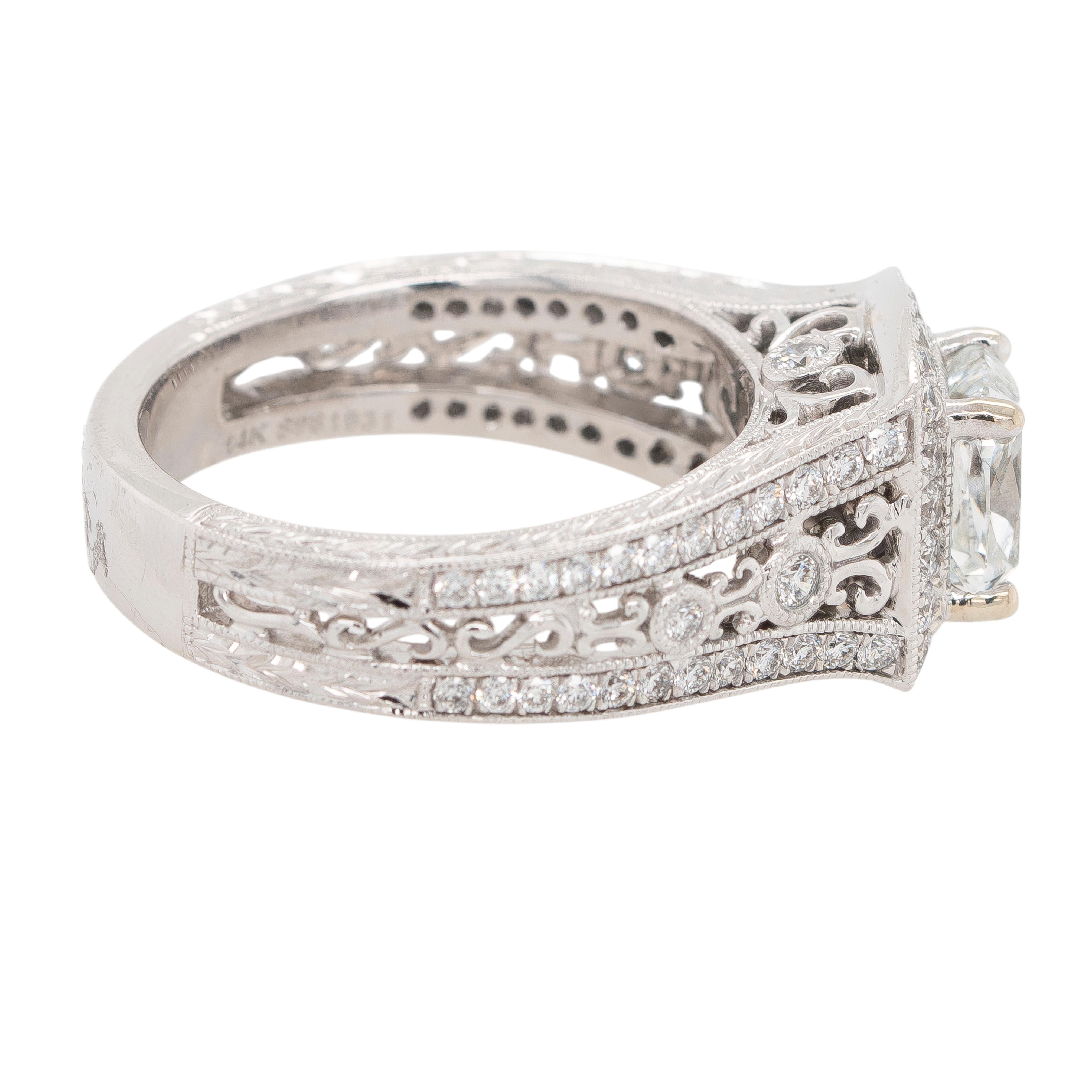 This stunning Gabriel & Co. engagement ring features a luxurious design crafted in 14k white gold. At its heart is a dazzling 1.21-carat natural cushion-cut diamond, certified by GIA (Report #3165739980). Graded E in color and VS2 in clarity, this