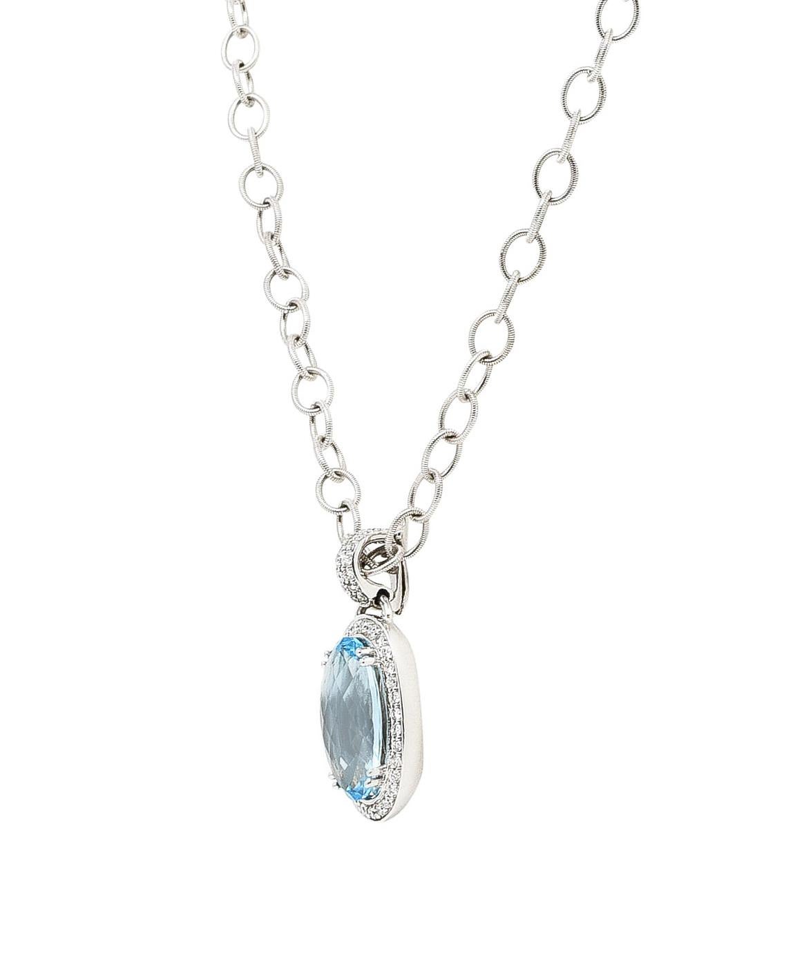 Cable chain necklace is comprised of deeply ridged oval links

Suspending an elongated oval drop that centers faceted oval cut topaz

Measuring approximately 18.0 x 10.0 mm - transparent with slightly greenish blue color

Surrounded by a round
