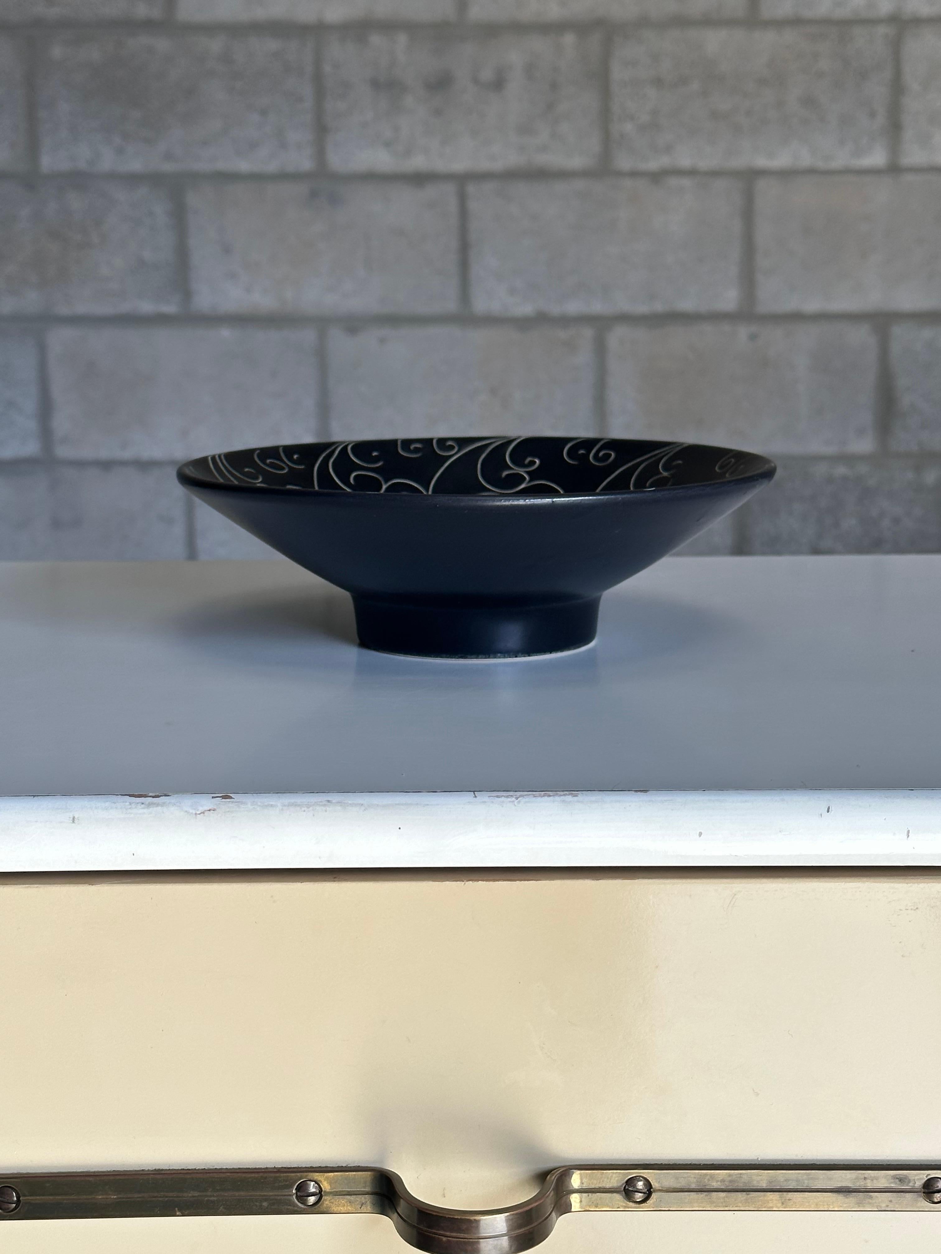 A Large decorative bowl produced by Gabriel Keramik of Sweden. Features a black glazed body with incised pattern detail. Great size and form. Would work well as a center piece bowl or fruit bowl. 