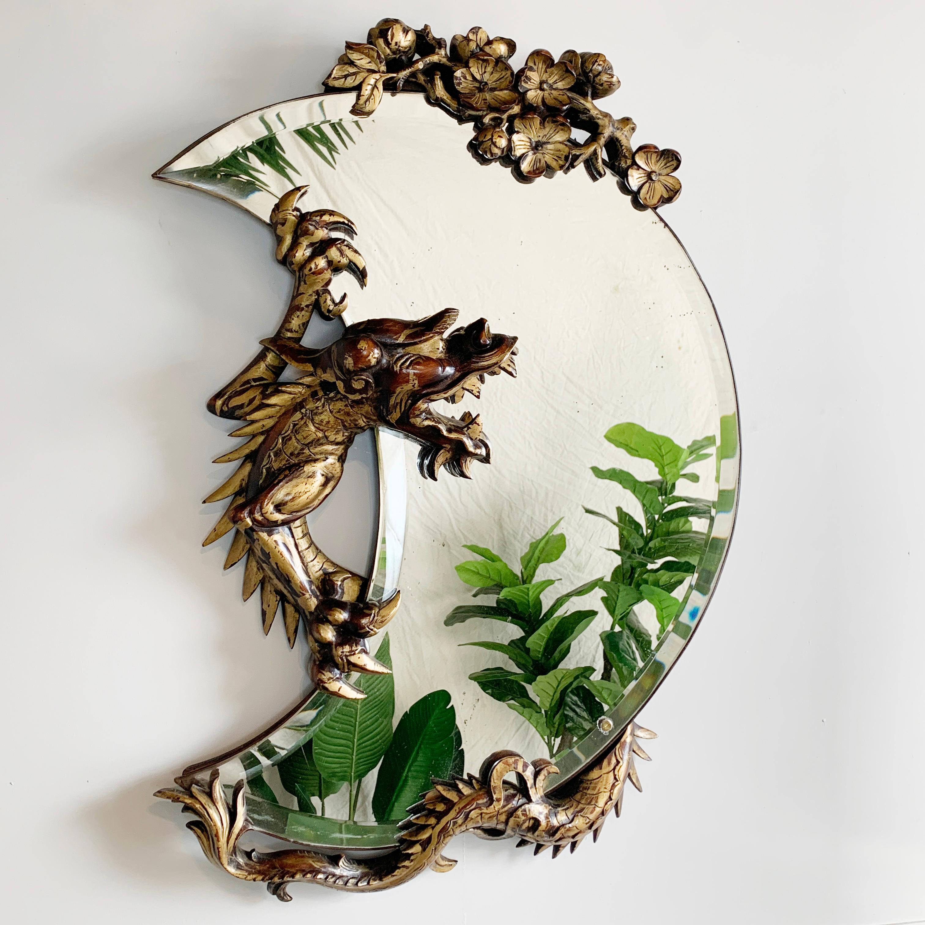 An incredible 19th century crescent mirror attributed to Gabriel Viardot, with deeply carved wooden gilt decorated Dragon gripping the plate in it’s claws, a spray of cherry blossom chinoisierie flowers at the base. This is an absolutely stunning