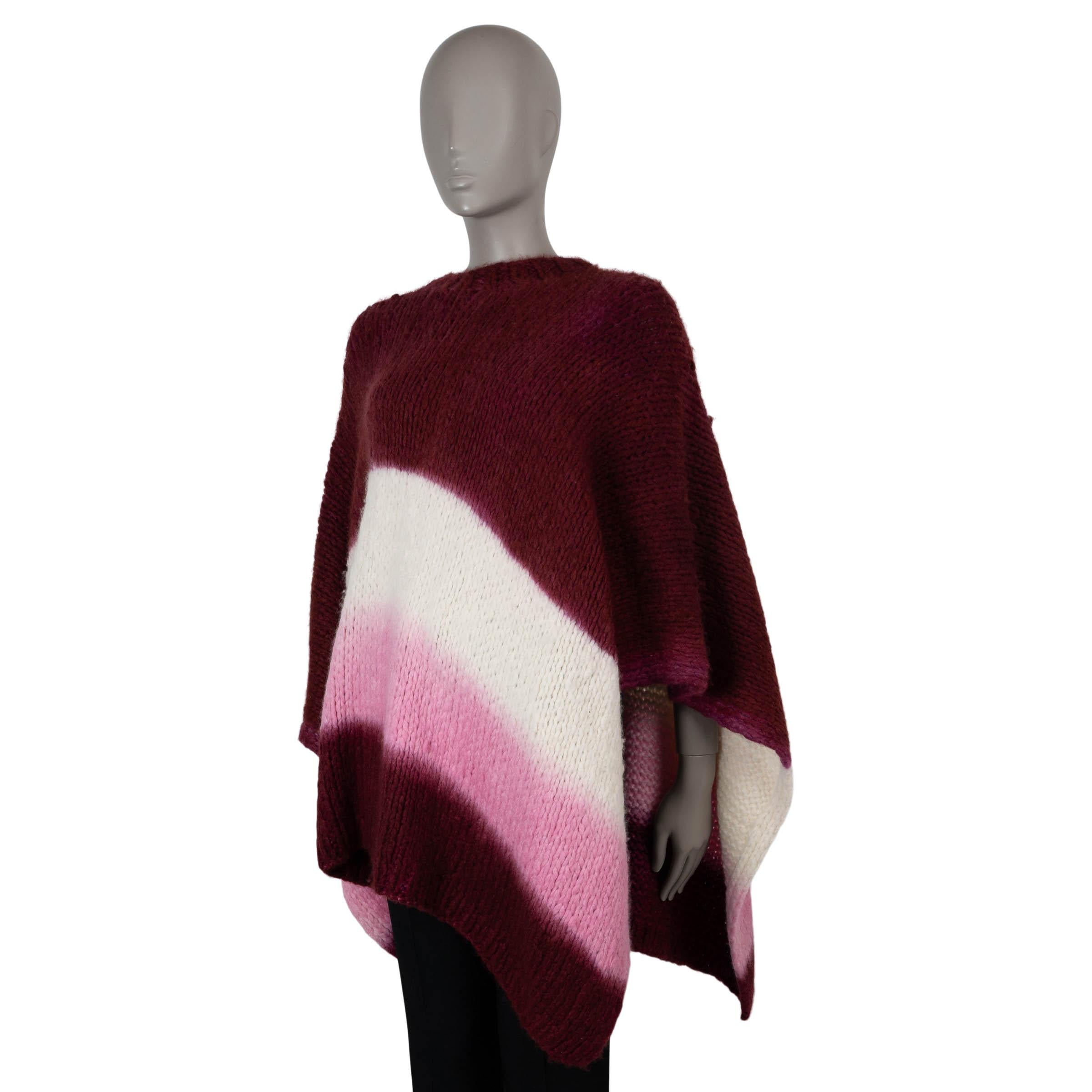 Questo poncho Lyla di Gabriela Hearst, autentico al 100%, è realizzato in cashmere Whiting (100%) a maglia grossa di colore bordeaux, bianco e rosa. Presenta una vestibilità oversize con spacchi laterali per facilitare i movimenti, maniche lunghe e