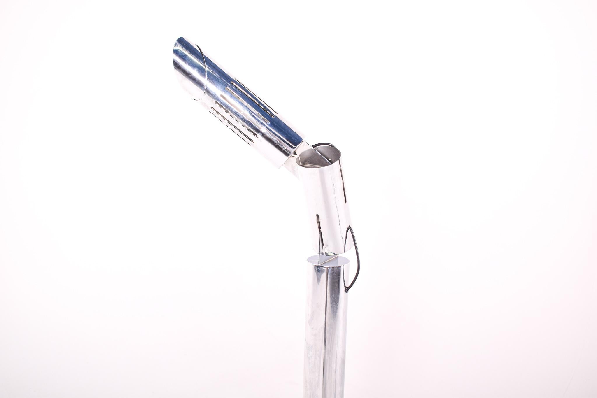 This chrome floor lamp, designed by Gabriele D'Ali around 1970 and manufactured by Enzo Francesconi, is a prime example of the sleek and functional design philosophy of the period. With its polished chrome finish, the lamp exudes a space-age