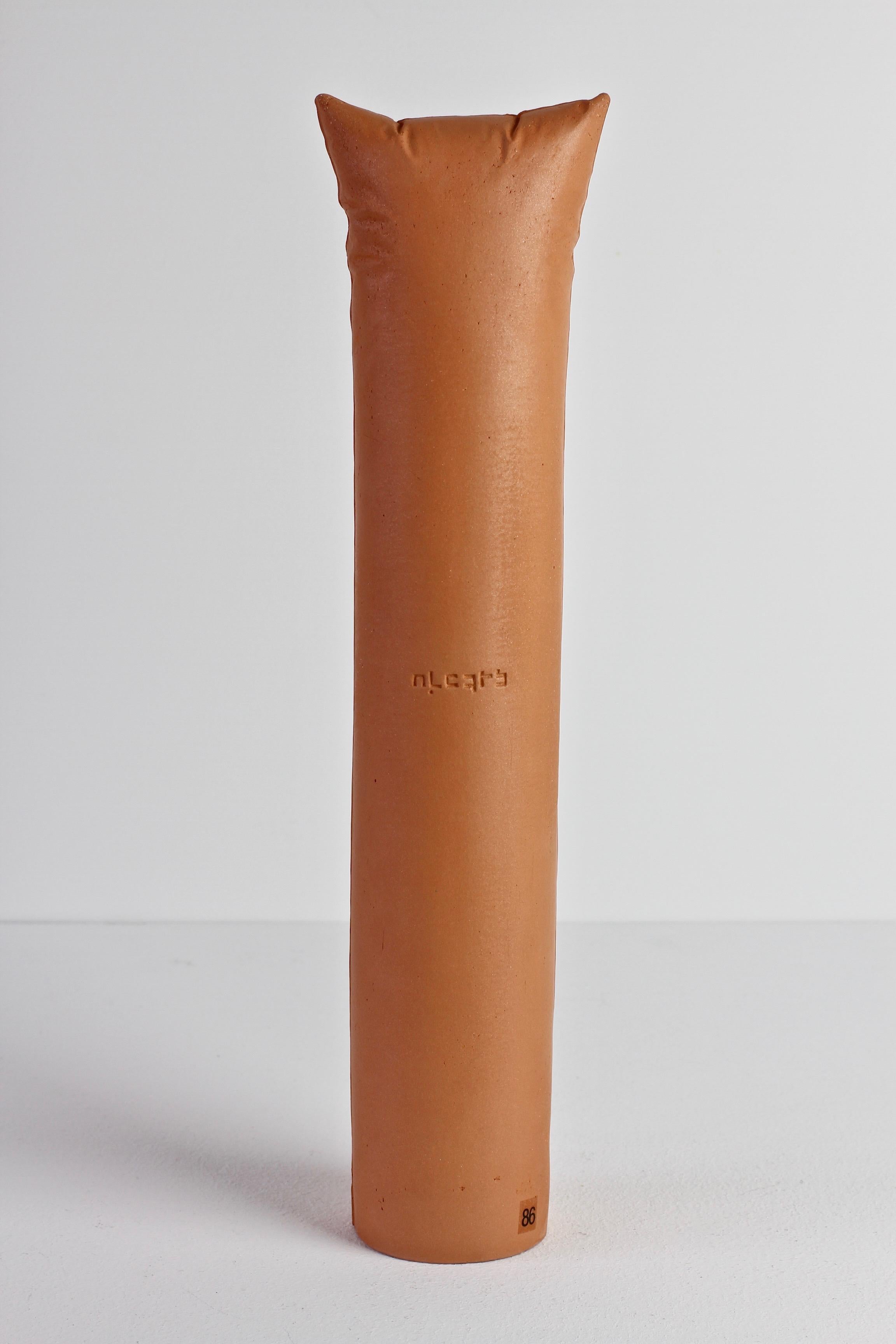 Gabriele Pütz vintage abstract realism ceramic artwork made in Germany, 1982. This work is made of a round clay tower / pillar with pillow edge details. On the body of the tower is written 'nichts' meaning 'nothing' in German. Unfortunately it