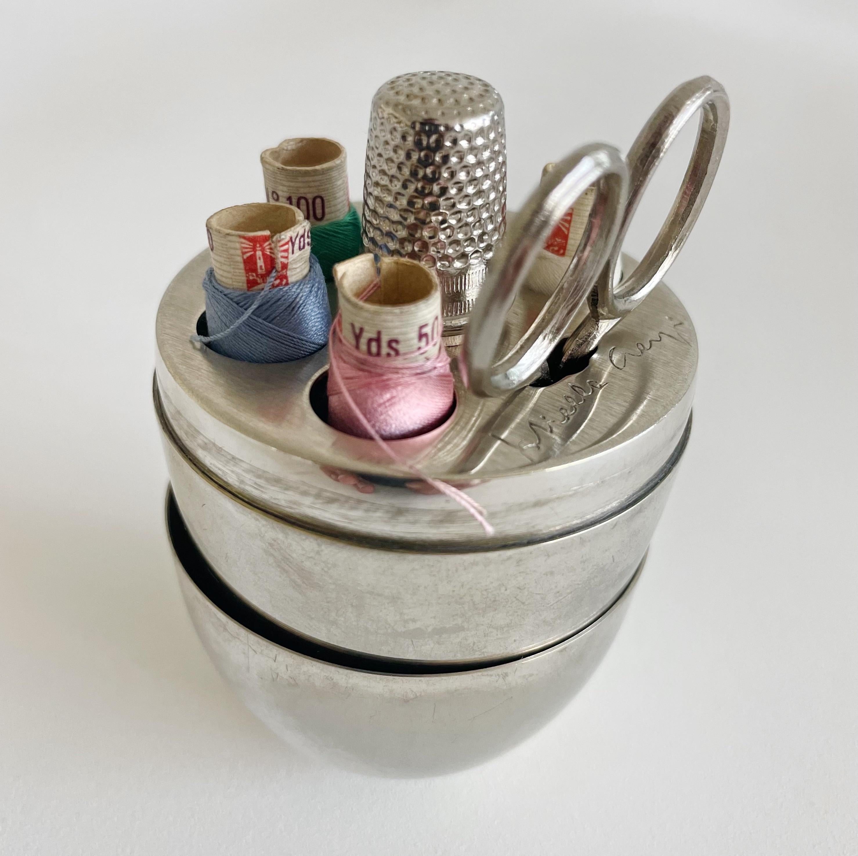 Gabriella Crespi silver plate sewing kit storage in a shape of an egg with scissors, thimble and Seta Faro Cocoon Silk Threads in assorted colors. Engraved signature on interior.