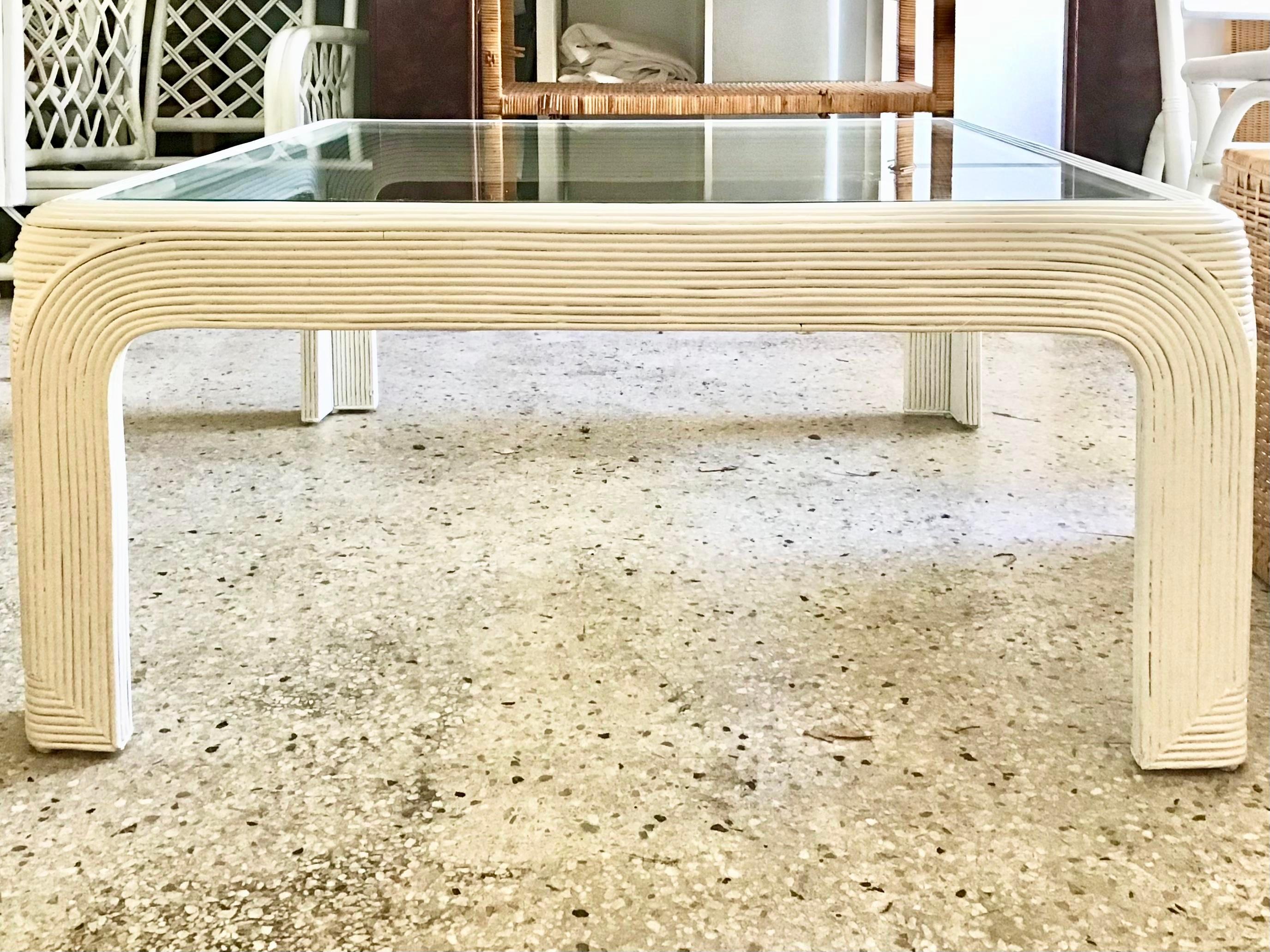 Boho chic pencil reed rattan square coffee table in the style of Gabriella Crespi, circa 1970s newly lacquered in white with a new glass top. A great addition to your boho chic inspired interiors.