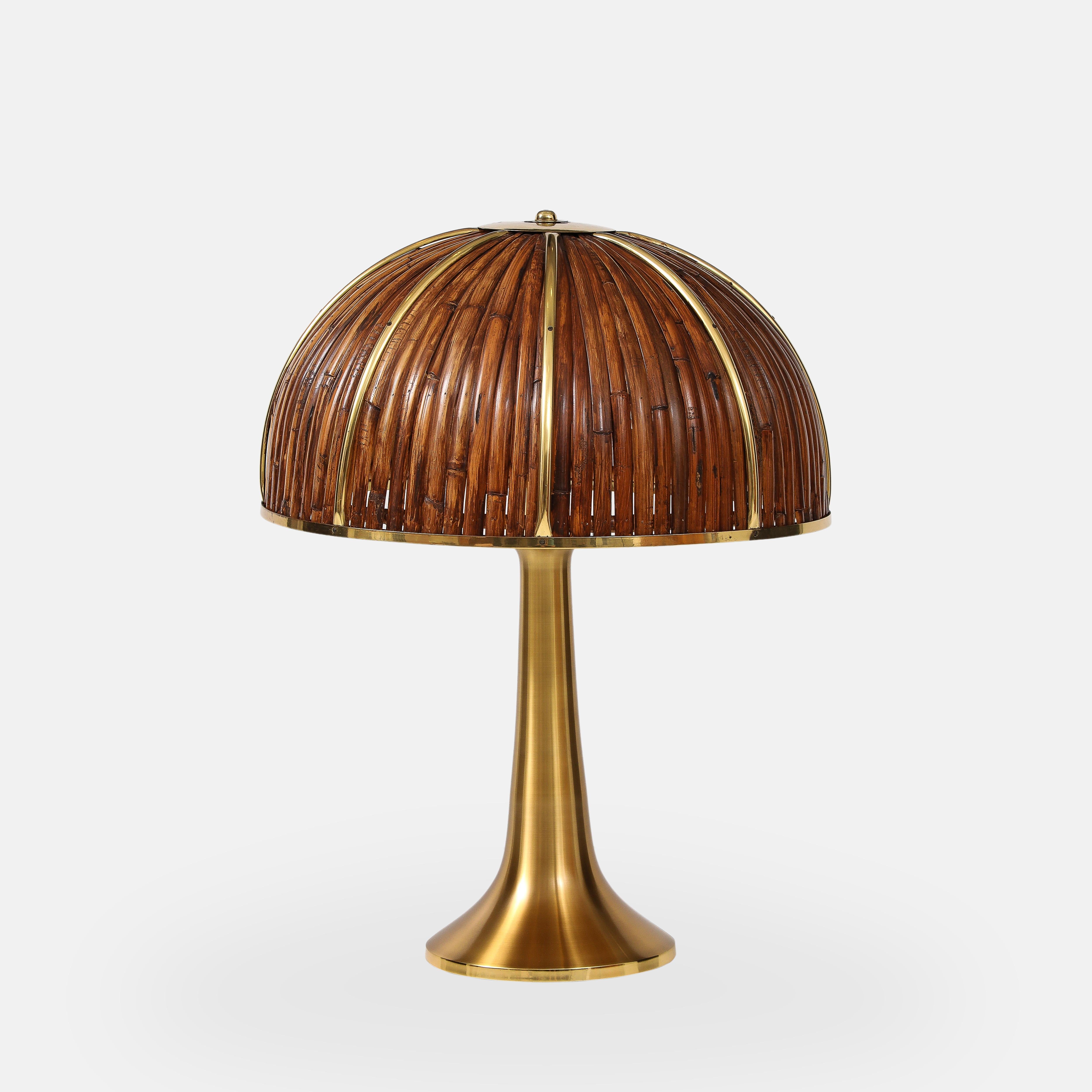 Gabriella Crespi rare large Fungo table lamp from the Rising Sun Series with lacquered bamboo strips and polished brass details on dome shade atop elegant flared brass base, Italy, 1970s.  Impressed with facsimile signature and artist’s cipher to