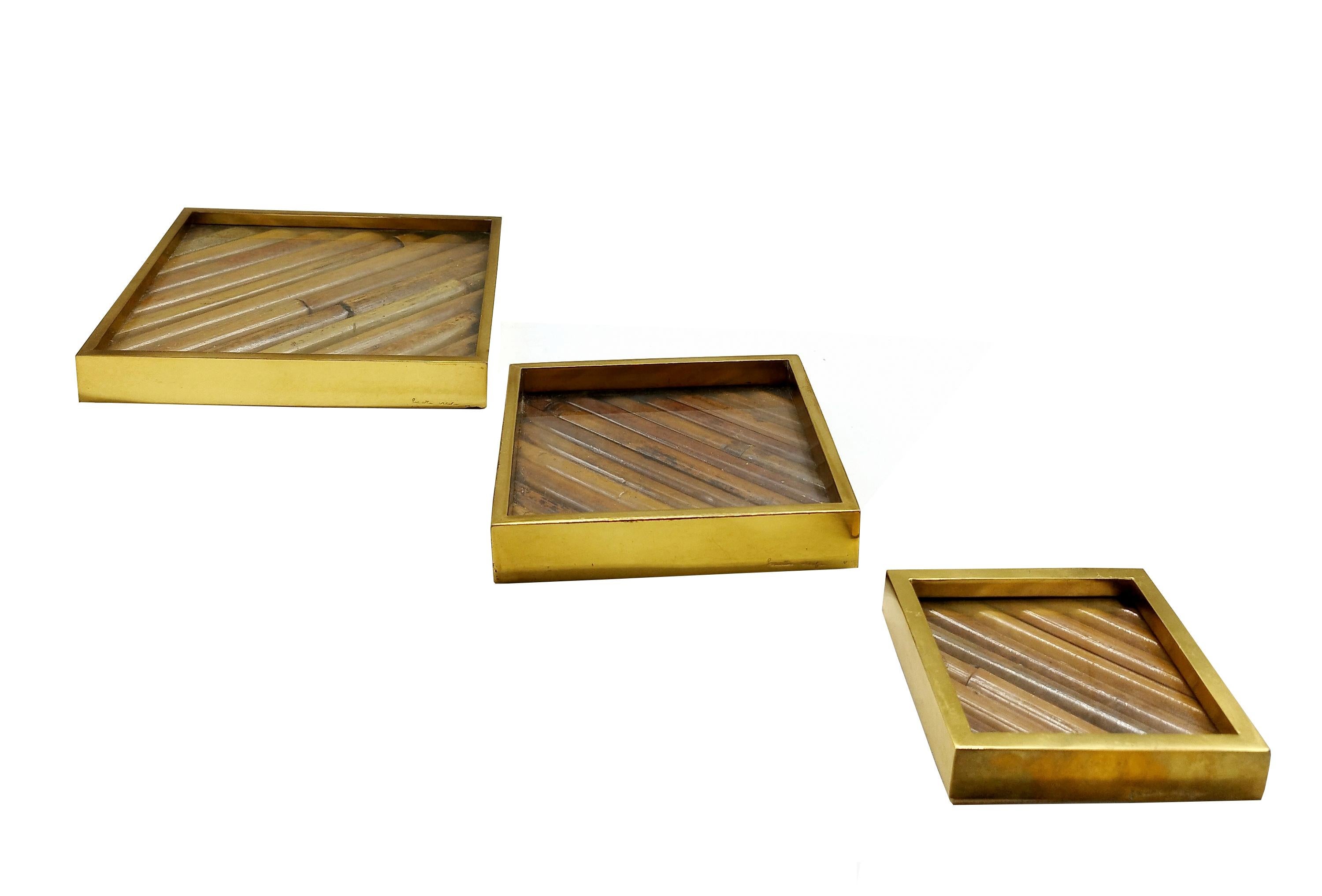 Gabriella Crespi, rare set of Rising Sun series tidy boxes with lacquered bamboo strips framed by polished brass sides and glass interior, Italy, 1970s.  Imprinted with Gabriella Crespi's signature on the side of each piece.  This elegant bamboo set