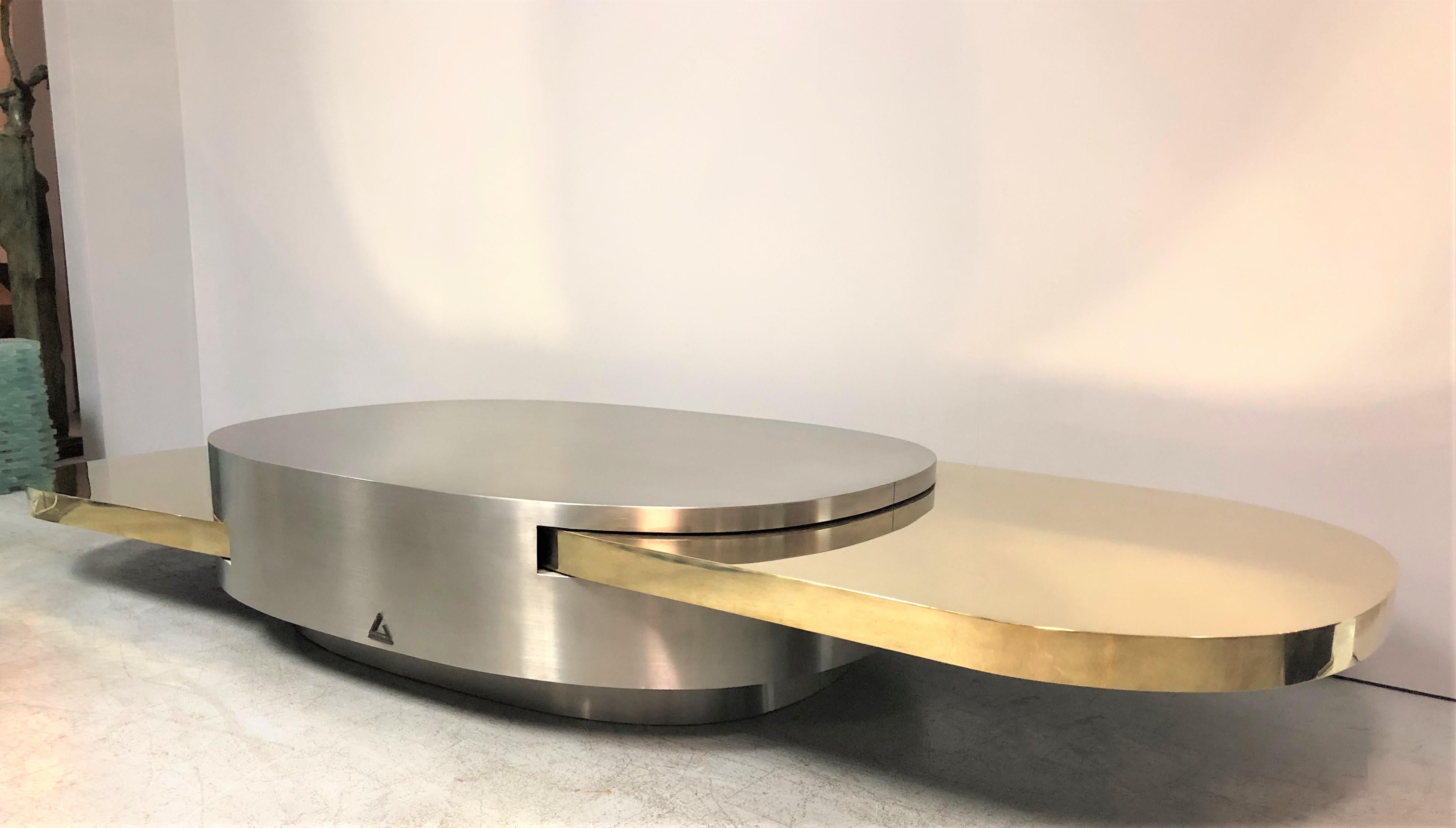 A rare stainless and brass coffee table by Gabriella Crespi. Ellisse from the Plurimi series. The oval body done in stainless steel with 2 sliding elliptical tops in brass. Signed and numbered and comes with certificate from the Achivio Gabriella
