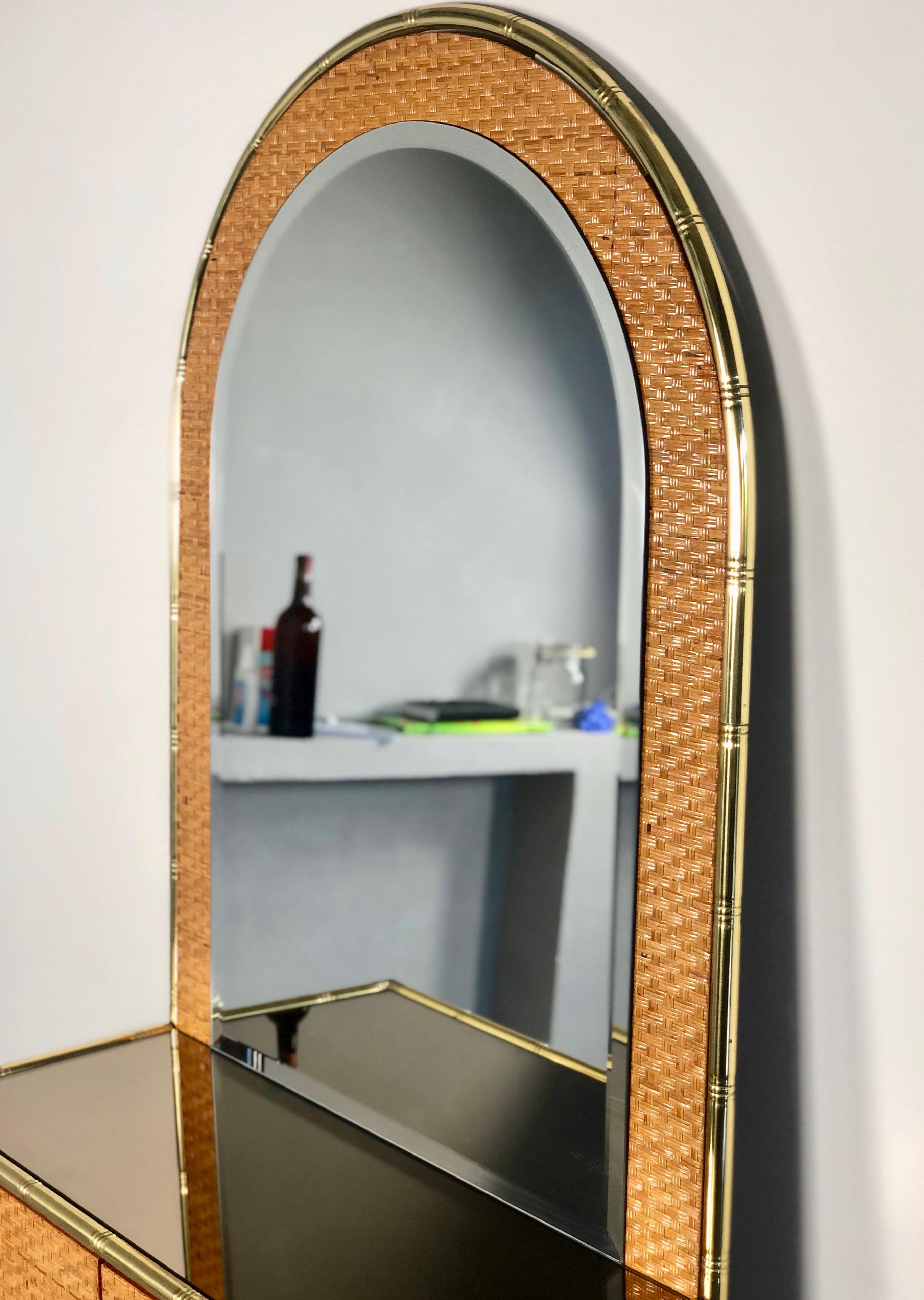 Splendid console etagere, made of bamboo with brass details. It features a mirrored bamboo shelf with two openable drawers in bamboo and a long mirror that covers the height of the console. Made in Italy, circa 1960.