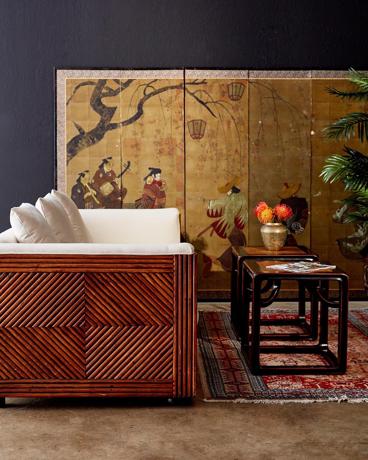 Fantastic Mid-Century Modern case sofa featuring a hardwood faux-bamboo rattan frame in the manner of Gabriella Crespi. Incredible geometric patterns decorate the ends and front of this sofa, reminiscent of Art Deco pieces with modern lines and