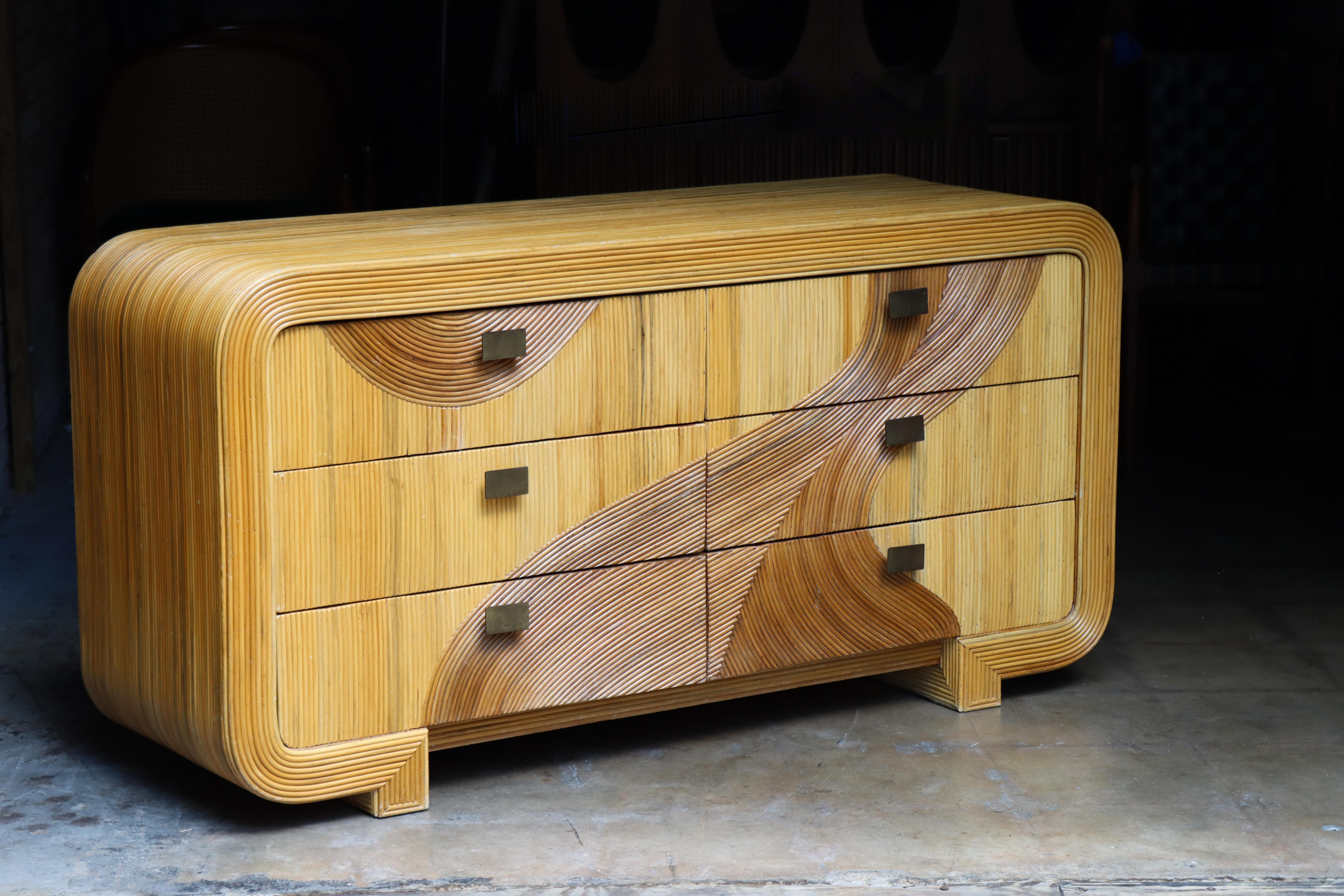 Exceptional six drawer dresser and mirror, designed in the style of much sought-after Gabriella Crespi. Crafted from bent reed rattan, this example features an organic movement that seems to flow upward. The reed projects a fabulous warmth, finish