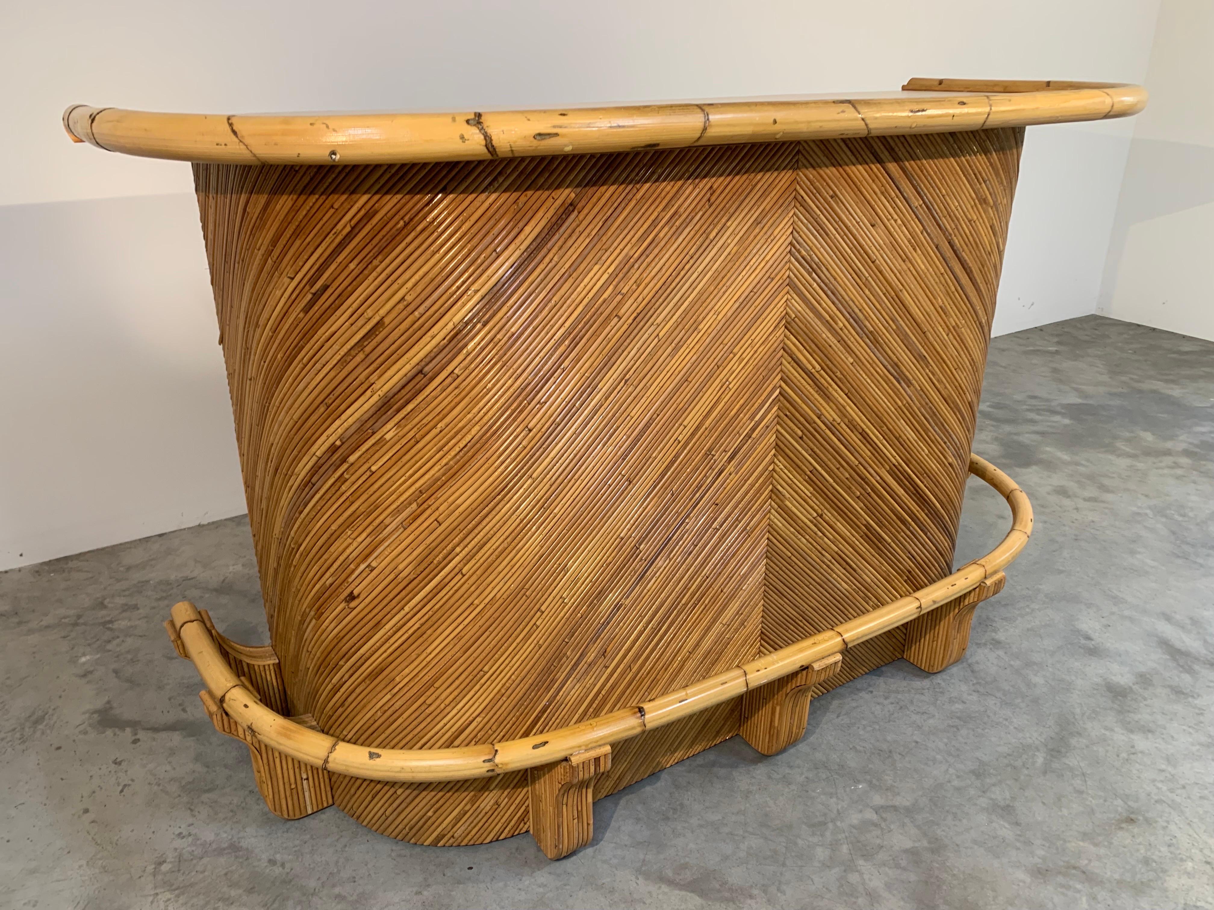 A stunning bamboo and pencil Reed dry bar having curved frame with bamboo footrest and armrest. A fantastic design in phenomenal condition having been gently used in a private residence. All of the Reed and bamboo are in fantastic conditions having