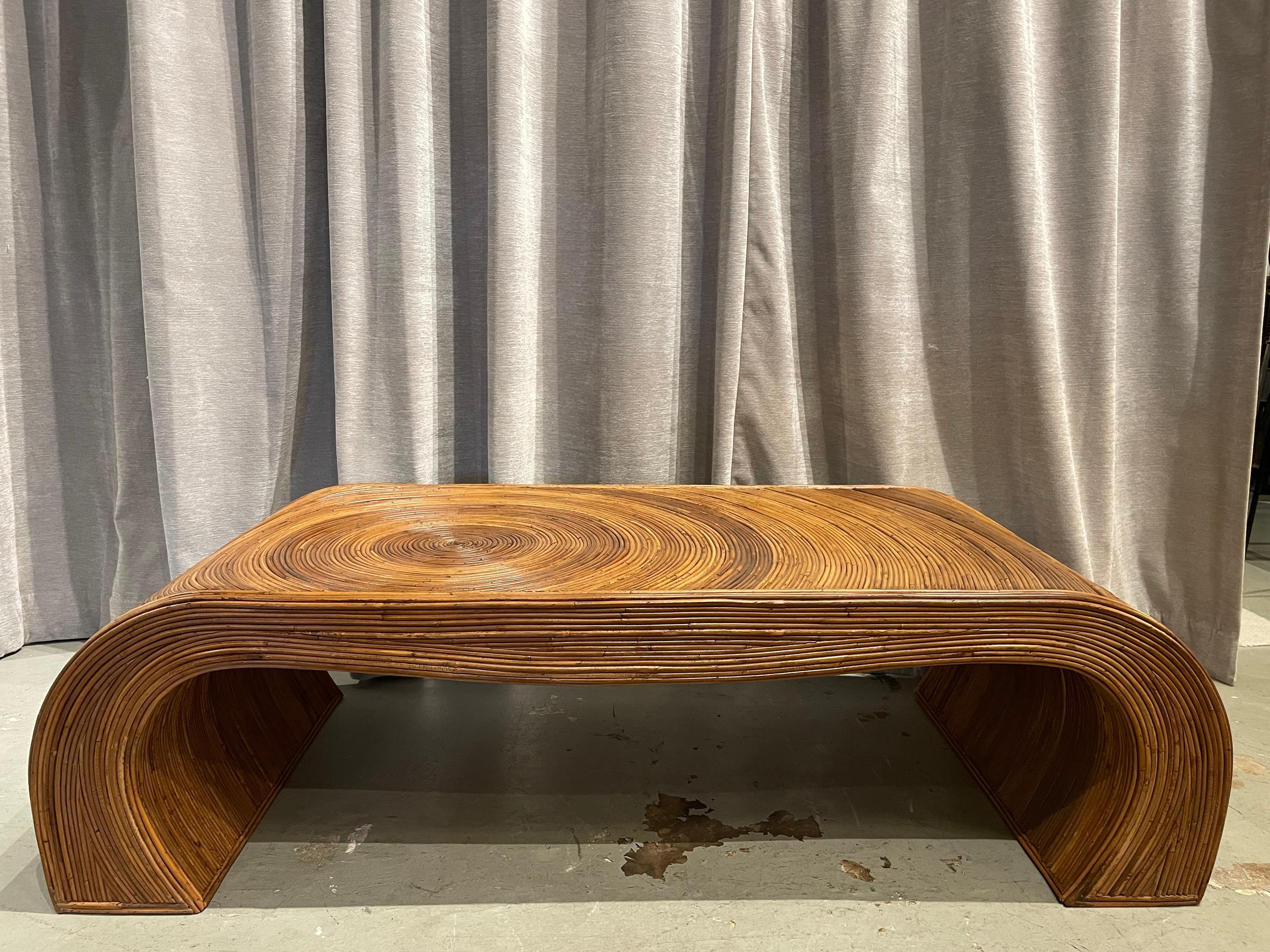 This is a very special and artfully worked coffee table made with split reed bamboo in a very intricate design and in arch form. The bent split reeds vary in color and tonality to give a richness of organic earth tones.