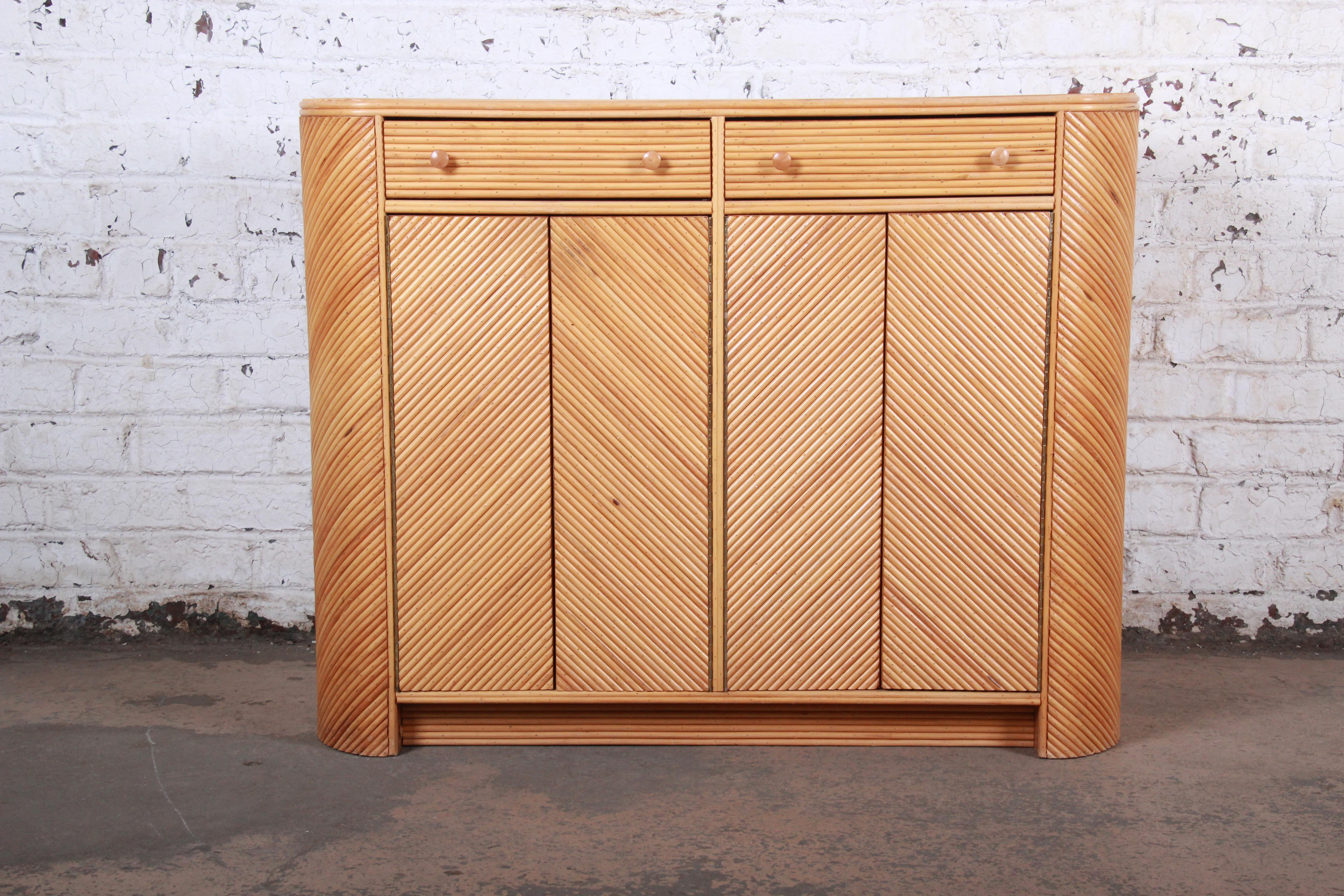 An exceptional midcentury Hollywood Regency split reed rattan compact sideboard cabinet

USA, circa 1970s

Split reed and rattan

Measures: 46