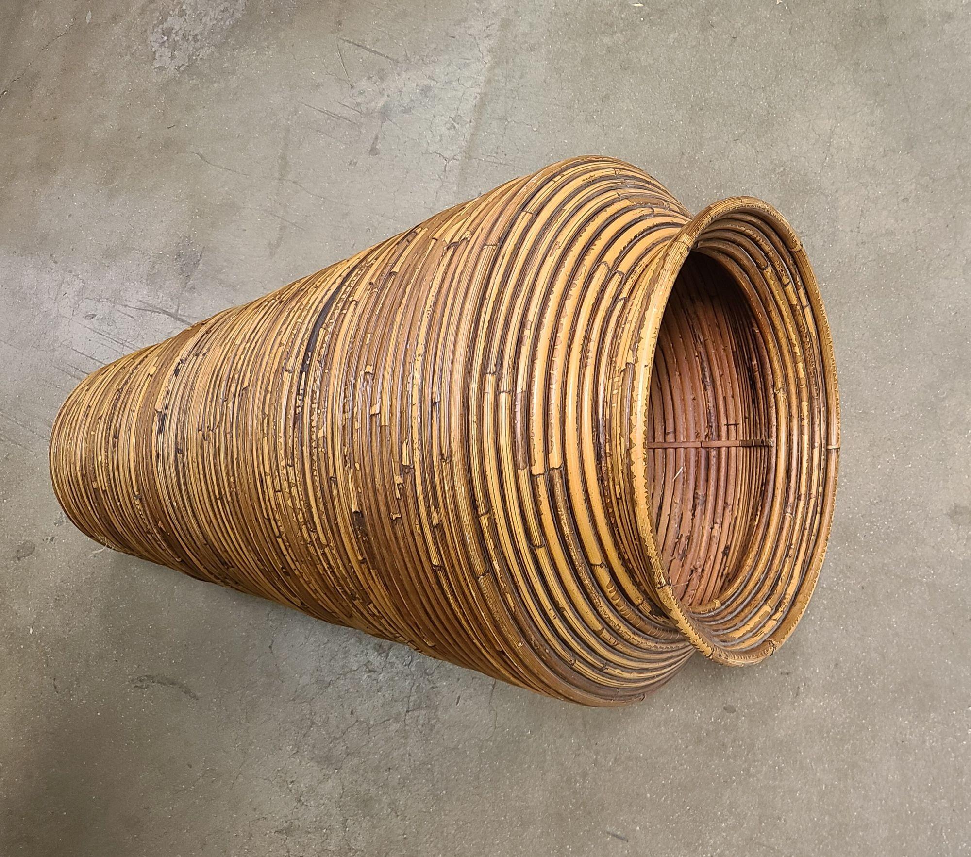 Large 2' tapered floor rattan vase made from stacked reed pencil rattan rings. Perfect for holding dried arrangements or simply standing on its own.
Measurements are approximately 27