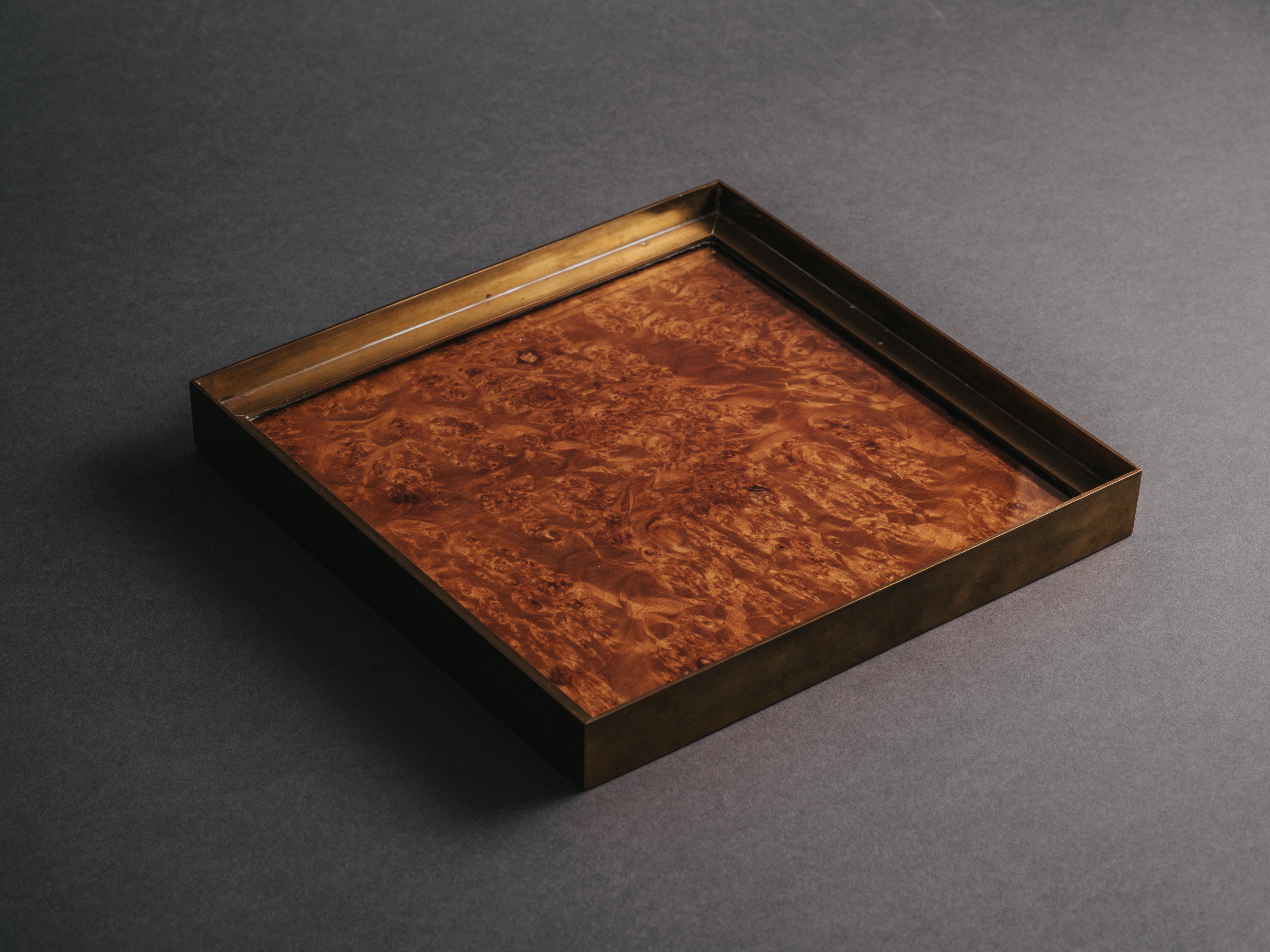 Square vide poche (Italian: svuotatasche) by Gabriella Crespi, comprising a glass-covered briar wood burl interior framed in lacquered, solid brass. Retains original felt and brass mounting corners to underside. Engraved signature to frame which