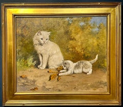 Cats at play, portrait of a cat and a Kitten playing with a glove in a landscape