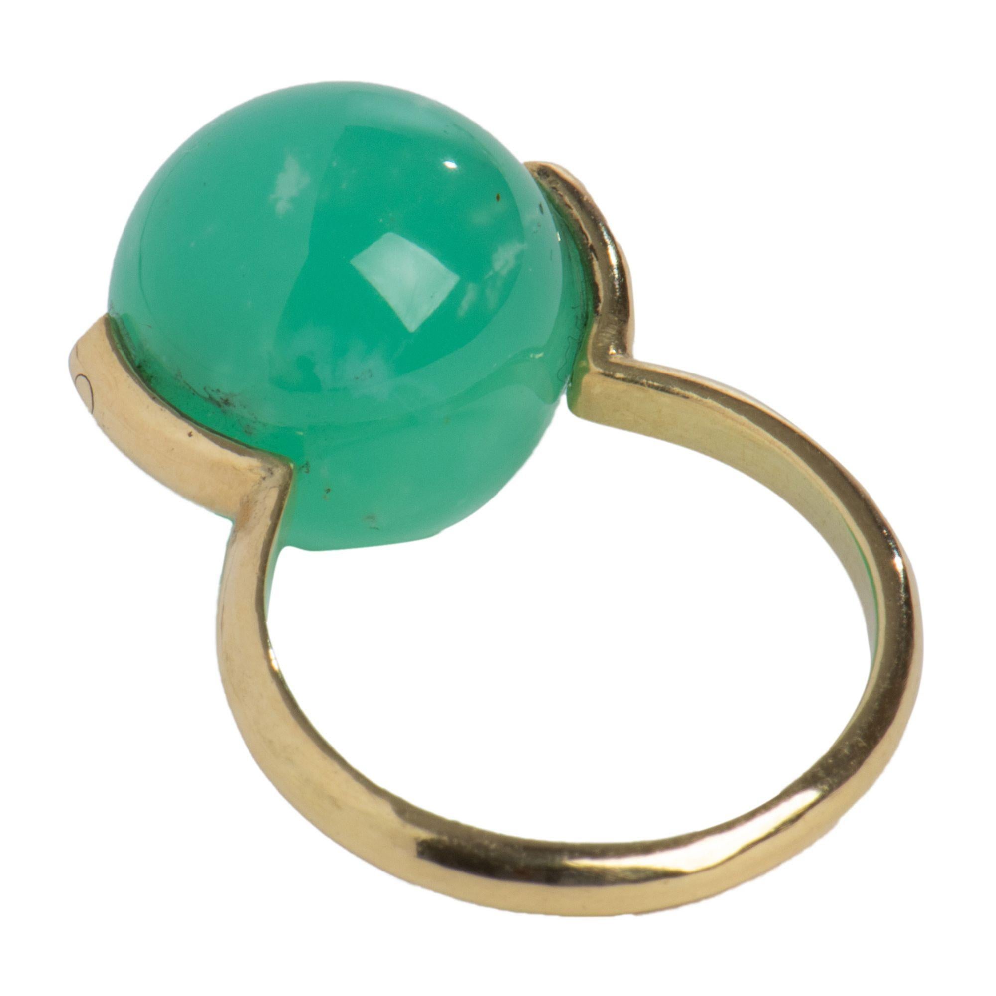 Bright (dare we call it joyous?) green crysoprase is the color of spring, and its slight translucence is as enchanting as that first warm day after winter. This beautiful round stone is caught in Gabrielle's 