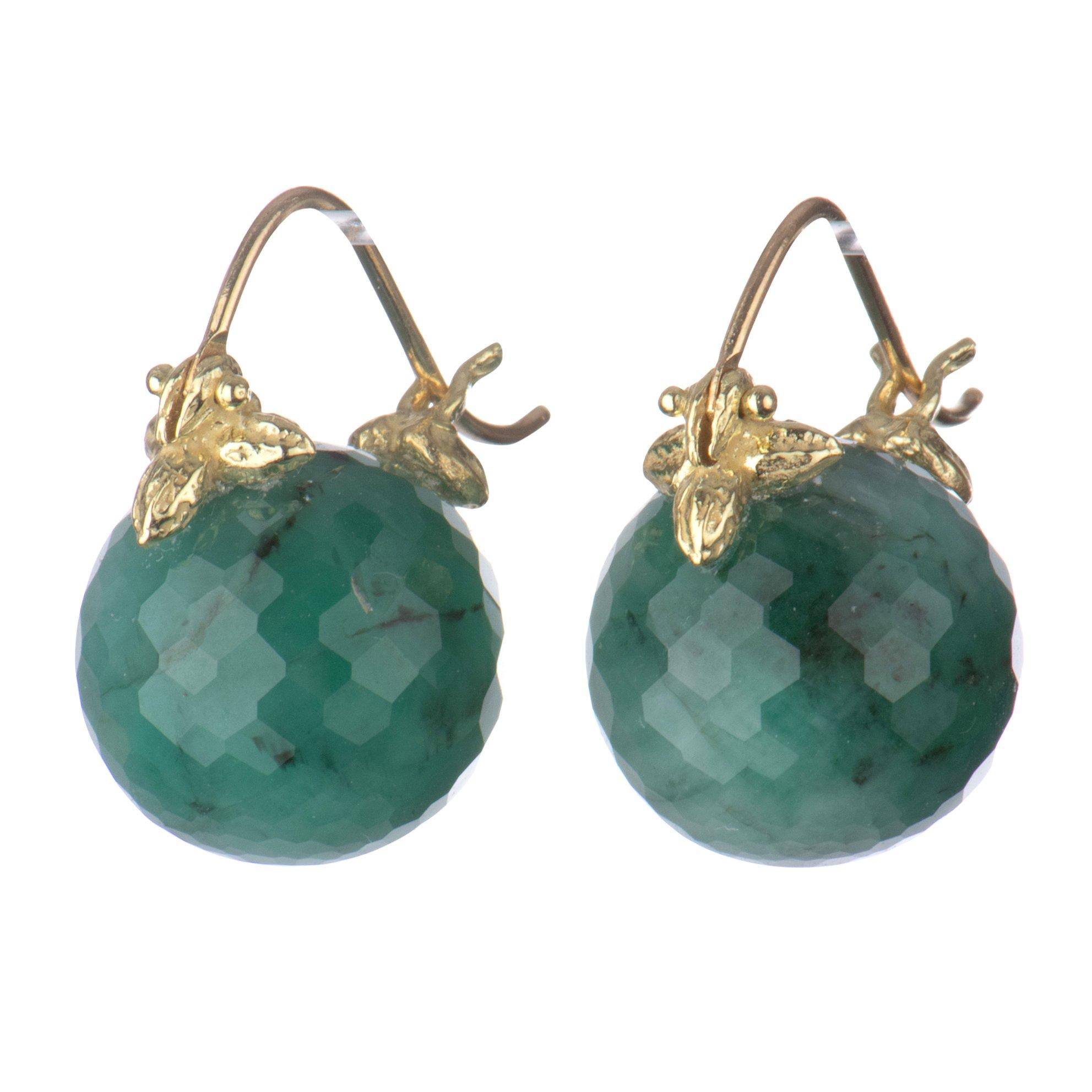 The stunning green that is emerald is a show-stopper in these faceted round drops, kissed with matrix shadows and clasped just so by Gabrielle's 18k Flyer setting.

12mm faceted emerald 18K Flyer earrings