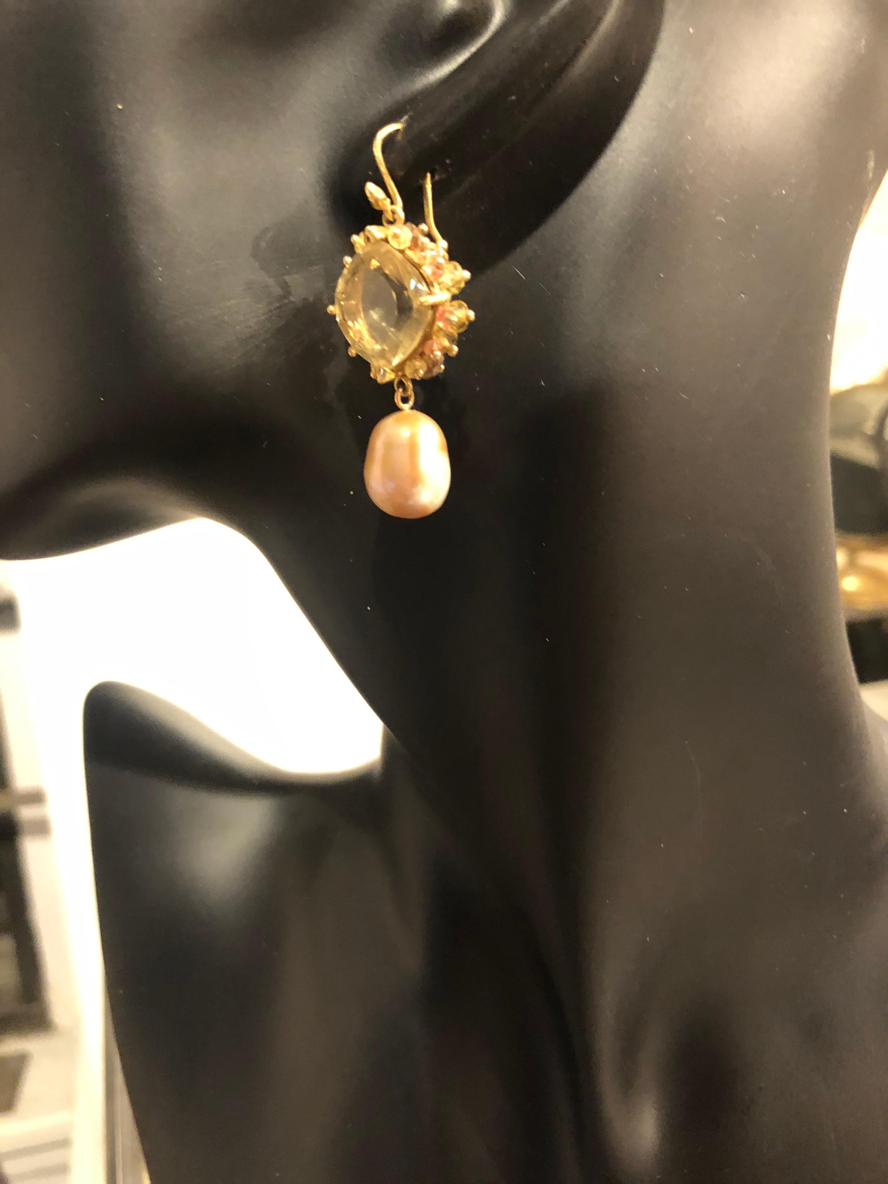 There is a certain woman who can define style with her own flair and joy for living—and this earring is for her. At once original and classic, this design is defined by a pair of remarkable faceted oro verde center stones, surrounded by prong set