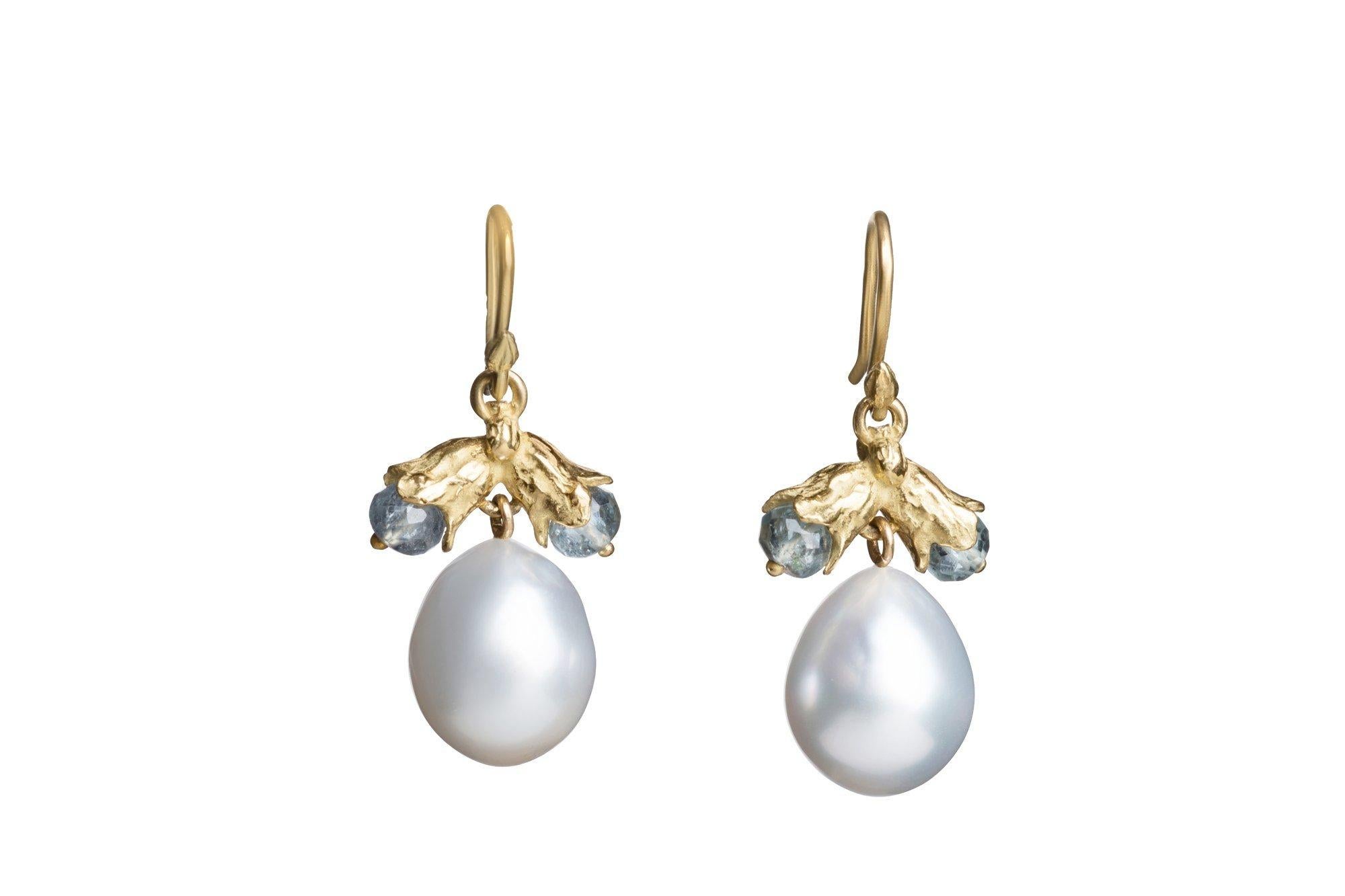Tiny tourmaline-studded bluebells float above slightly mismatched, stormy blue-gray South Sea pearl drops, making for a stunning and truly original pair of dangle earrings. Are you an original? These are for you.