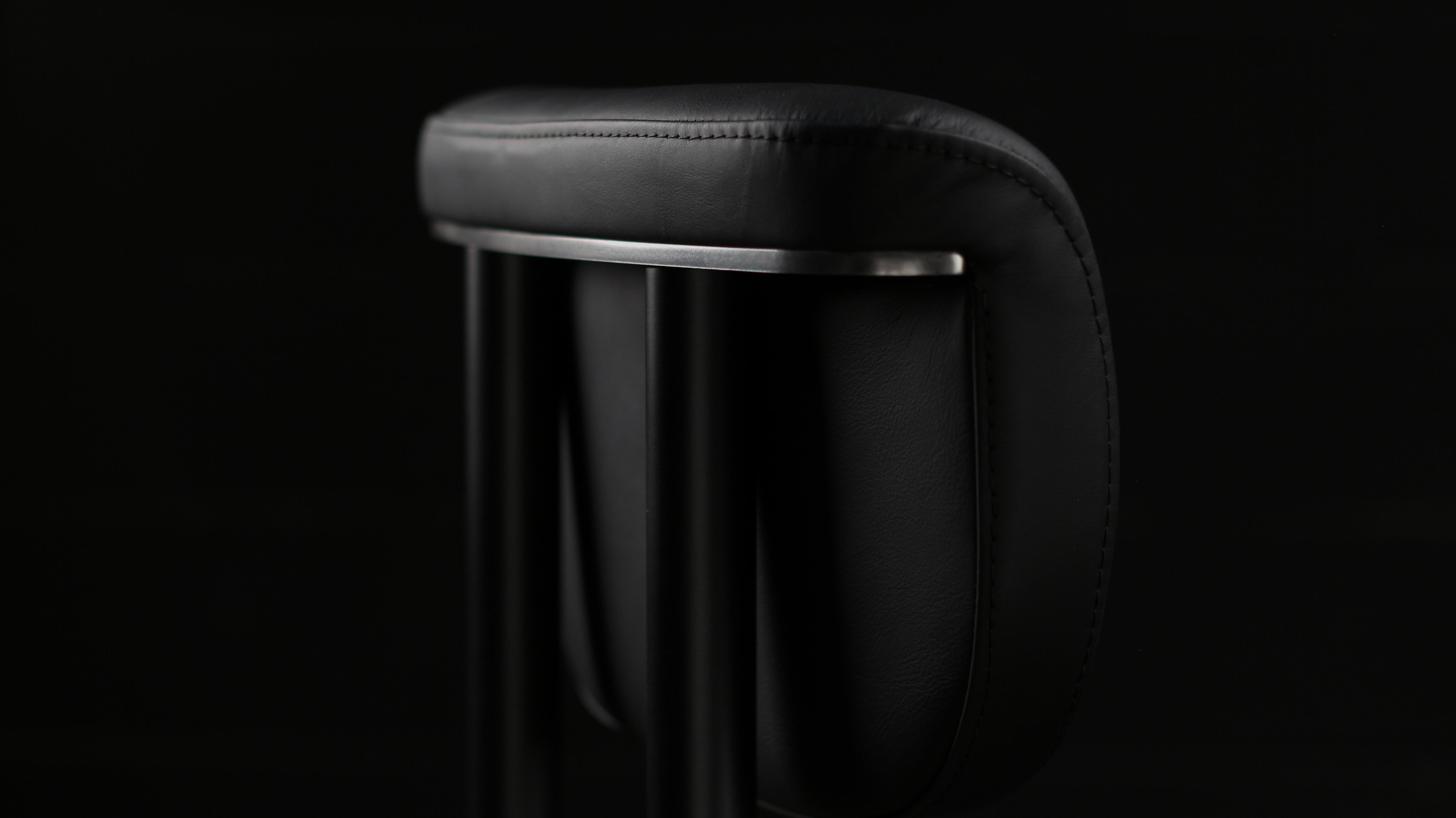 The Gadot dining chair is made to order.  Available in COM/COL. Shown here in a Blackened Steel frame & Black Nappa Automotive leather. Featuring a subtile Satin Nickel trim that will give a distinguished touch to your space. This