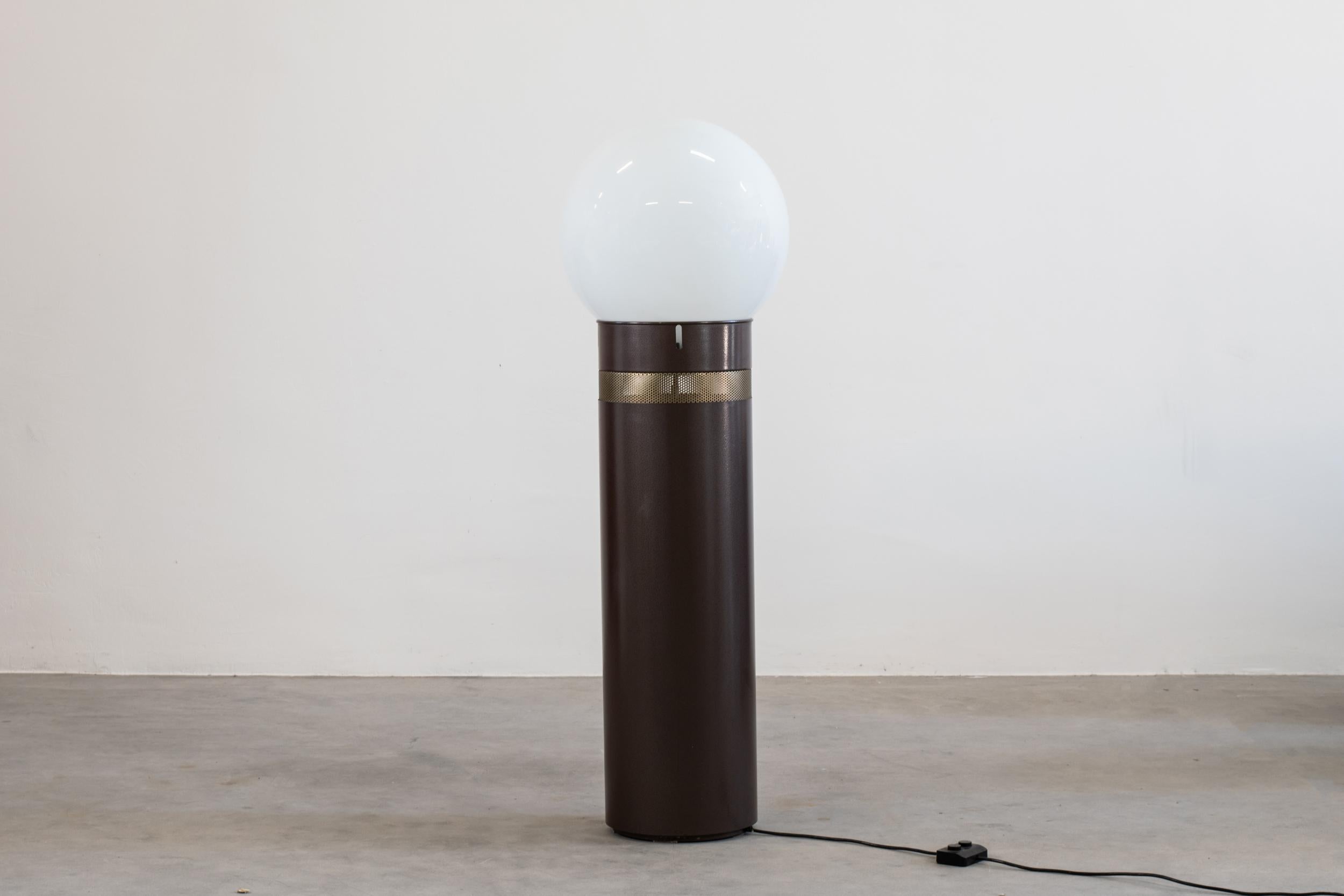 Oracolo floor lamp with a cilindical basement in brown lacquered metal with a pierced stainless steel section, and a blown glass diffuser. 

This lamp was designed by Gae Aulenti in 1969 for Artemide Italy.

Gae Aulenti was a prominent postwar