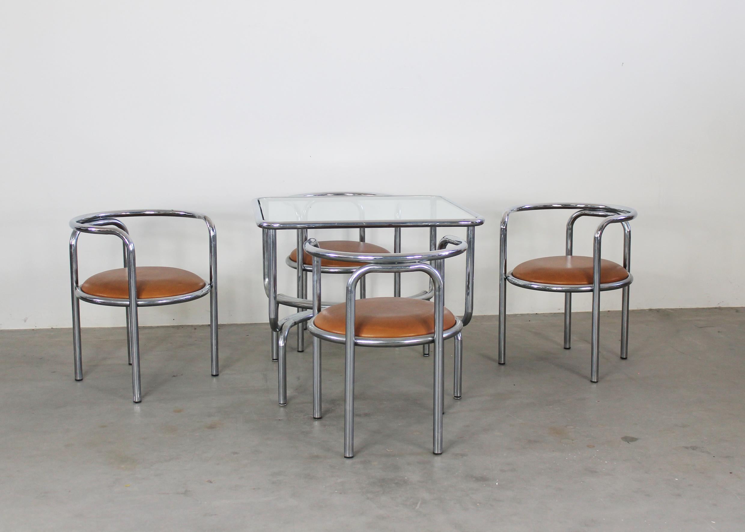 Locus Solus set is composed of four chairs with a structure in tubular steel a seat in padded leather and a table with a frame in tubular steel and a glass table top. 

The Locus Solus series was designed by Gae Aulenti in 1964 and produced by