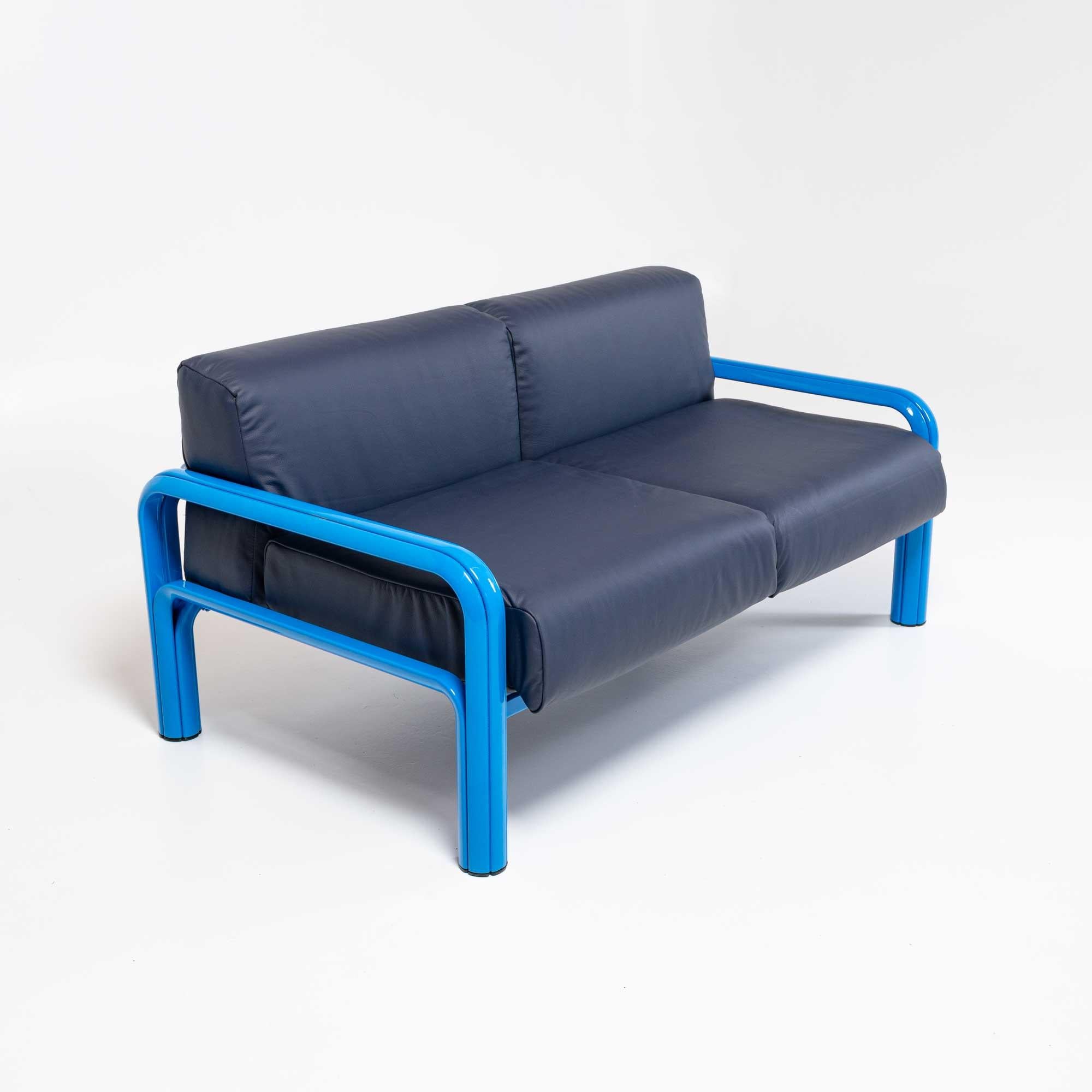 Loveseat from Gae Aulenti’s eponymous 1976 collection for Knoll. Low, horizontal design features a rounded frame of extruded steel in newly powder coated baby blue and dense cushions re-upholstered in Elmo topgrain navy leather.

Dimensions: 60”