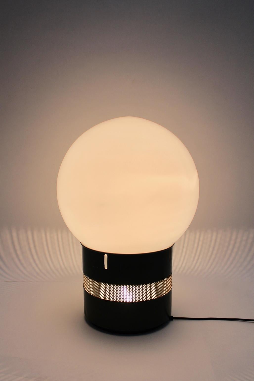 Gae Aulenti Mid-Century Modern vintage table lamp from glass and metal model Oracolo designed 1968 Italy and executed by Artemide, Pregnana Milanese Italy.
A white glass sphere sits atop a cylindrical column of brown enameled metal. This table lamp