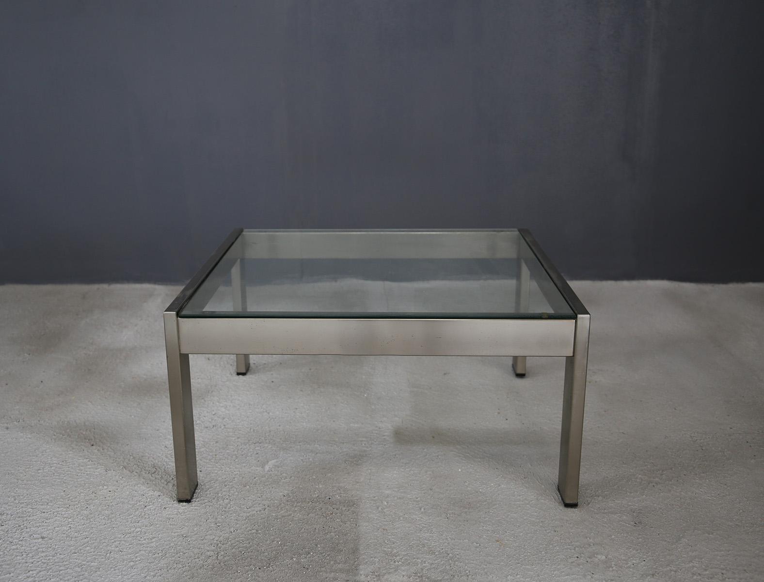 Gae Aulenti coffee table for the Rinascente shop Milan, 1970s. The coffee table is part of the TAU series exclusively for the La Rinascente department store in Milan. It is made of chrome-plated steel and its top is made of glass. Inside the table
