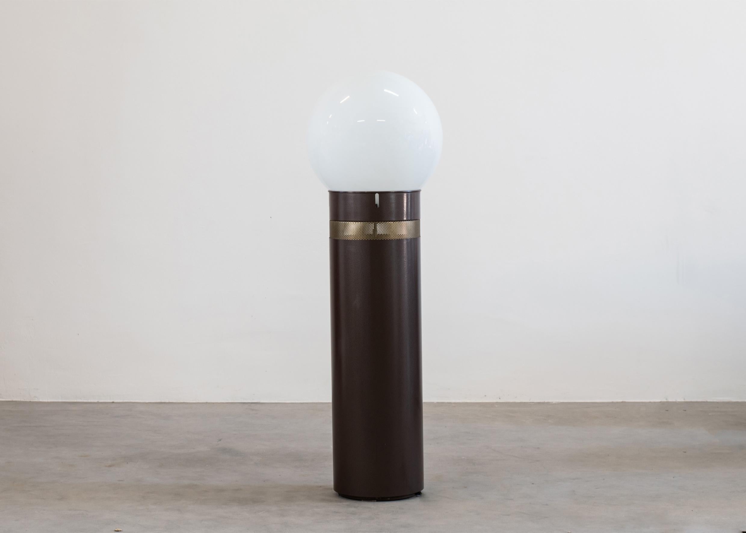 Oracolo floor lamp with a cilindical basement in brown lacquered metal with a pierced stainless steel section, and a blown glass diffuser. 

This lamp was designed by Gae Aulenti in 1969 for Artemide Italy.

Gae Aulenti was a prominent postwar