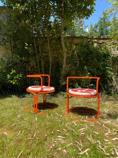 Gae Aulenti, orange lacquered steel armchairs