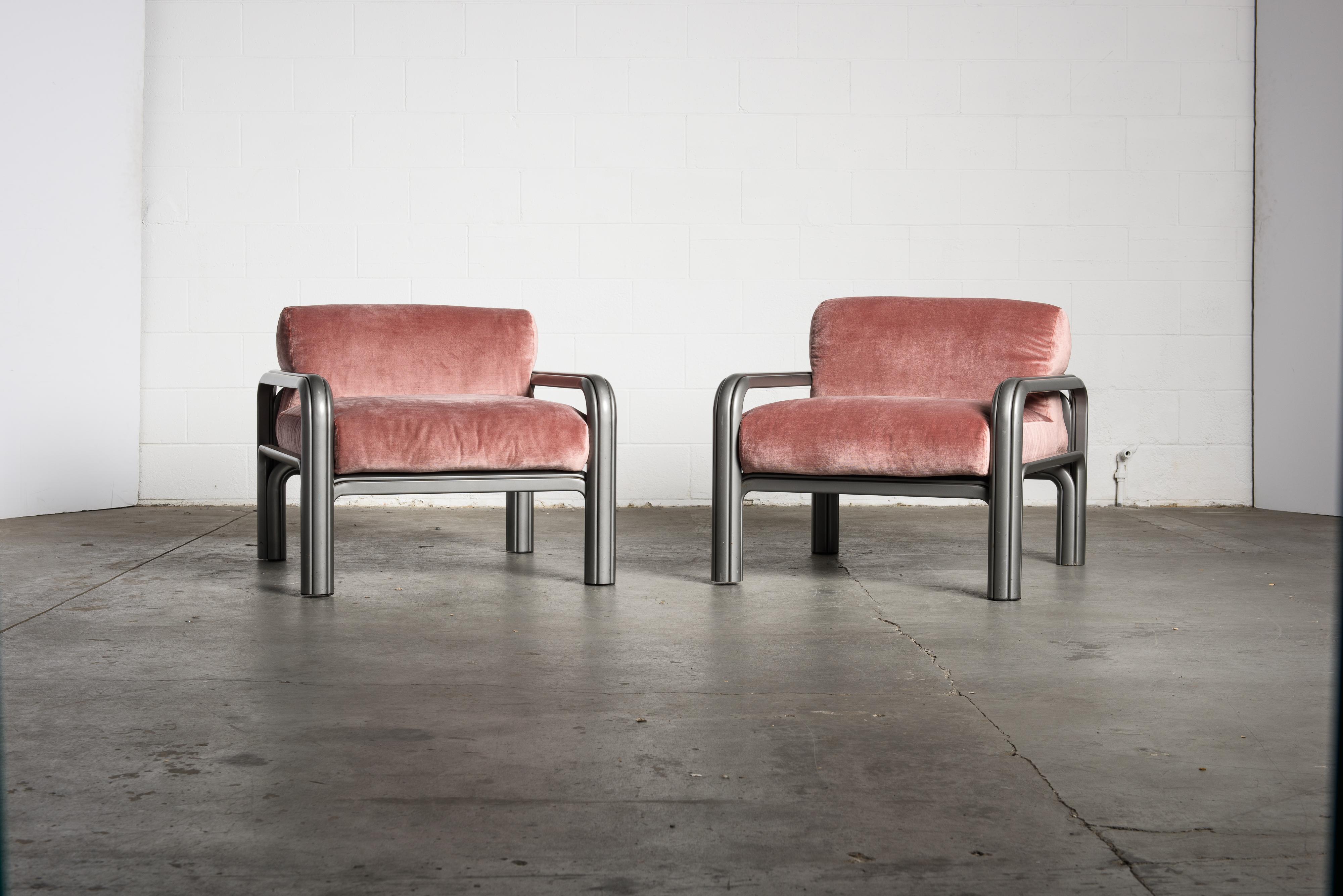 A fantastic pair of Gae Aulenti for Knoll International lounge chairs constructed of grey lacquered steel frames with pink velvet cushions. In recent years Gae Aulenti's designs have soared in demand as interior designers are now recognizing her