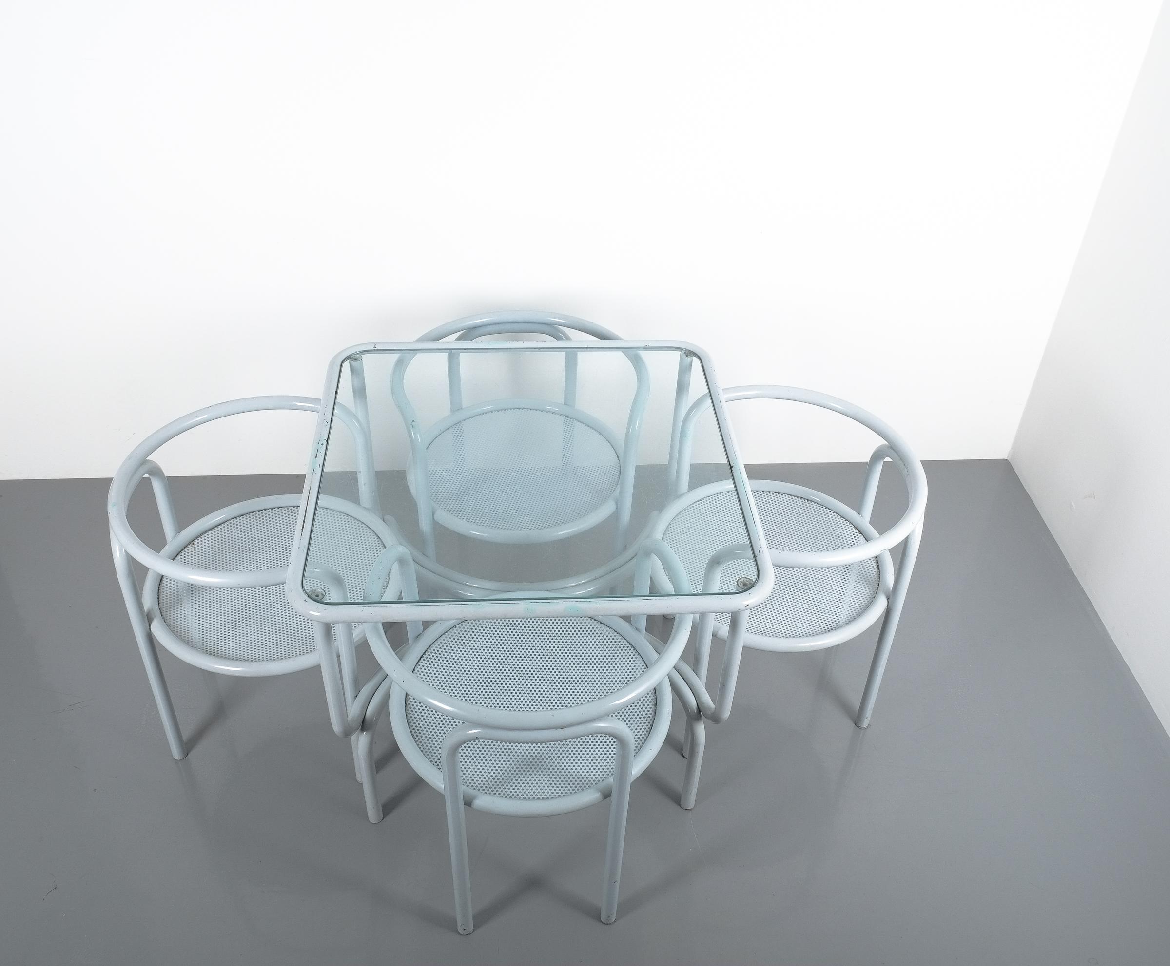 Gae Aulenti set of garden furniture metal grey locus solos midcentury. Nice set of 4 chairs and a table with original glass tabletop. Fair to good original condition, some parts show loss of color and stains of rust. The glass shows scratches and