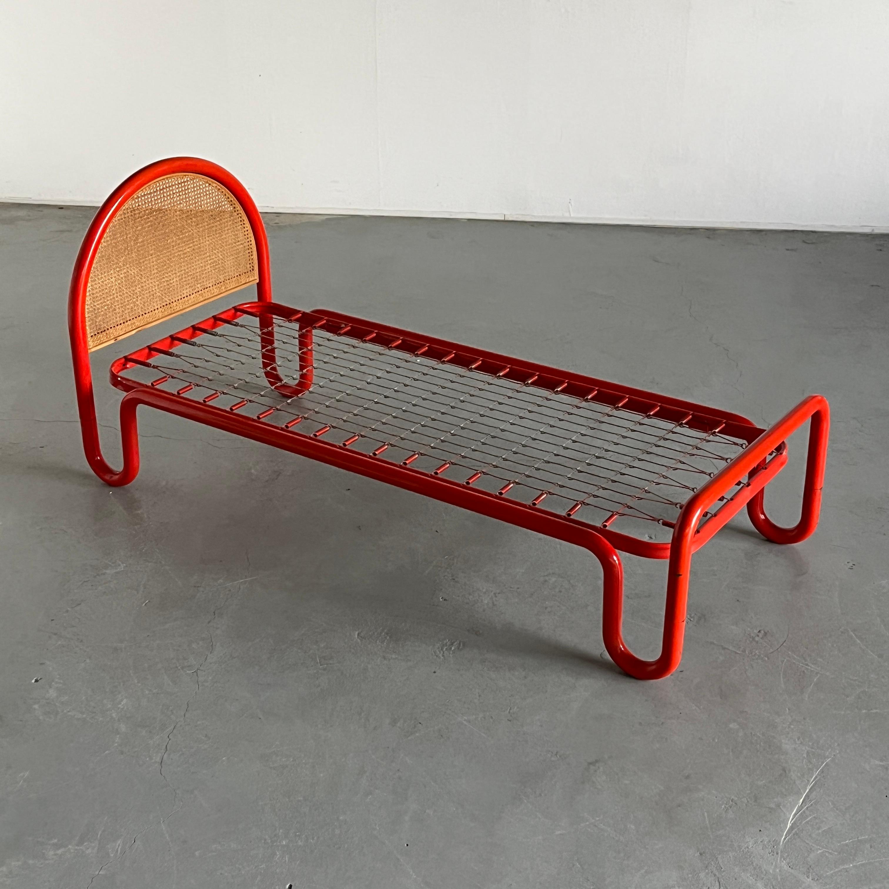 A unique modernist single bed frame in red powder coated tubular metal frame and a wooden caned headboard. Italian origin and production of the 1960s, sourced from the original owners.
Documented online as a Gae Aulenti design, but without verified