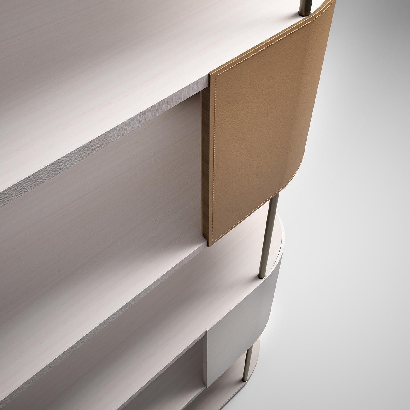 The unique volumetric identity characterizing Gae Aulenti Square in Milan inspired the proportions and lines of this stunning bookcase. Its airy design, resulting from the juxtaposition of five shelves supported by metal bars and accented with
