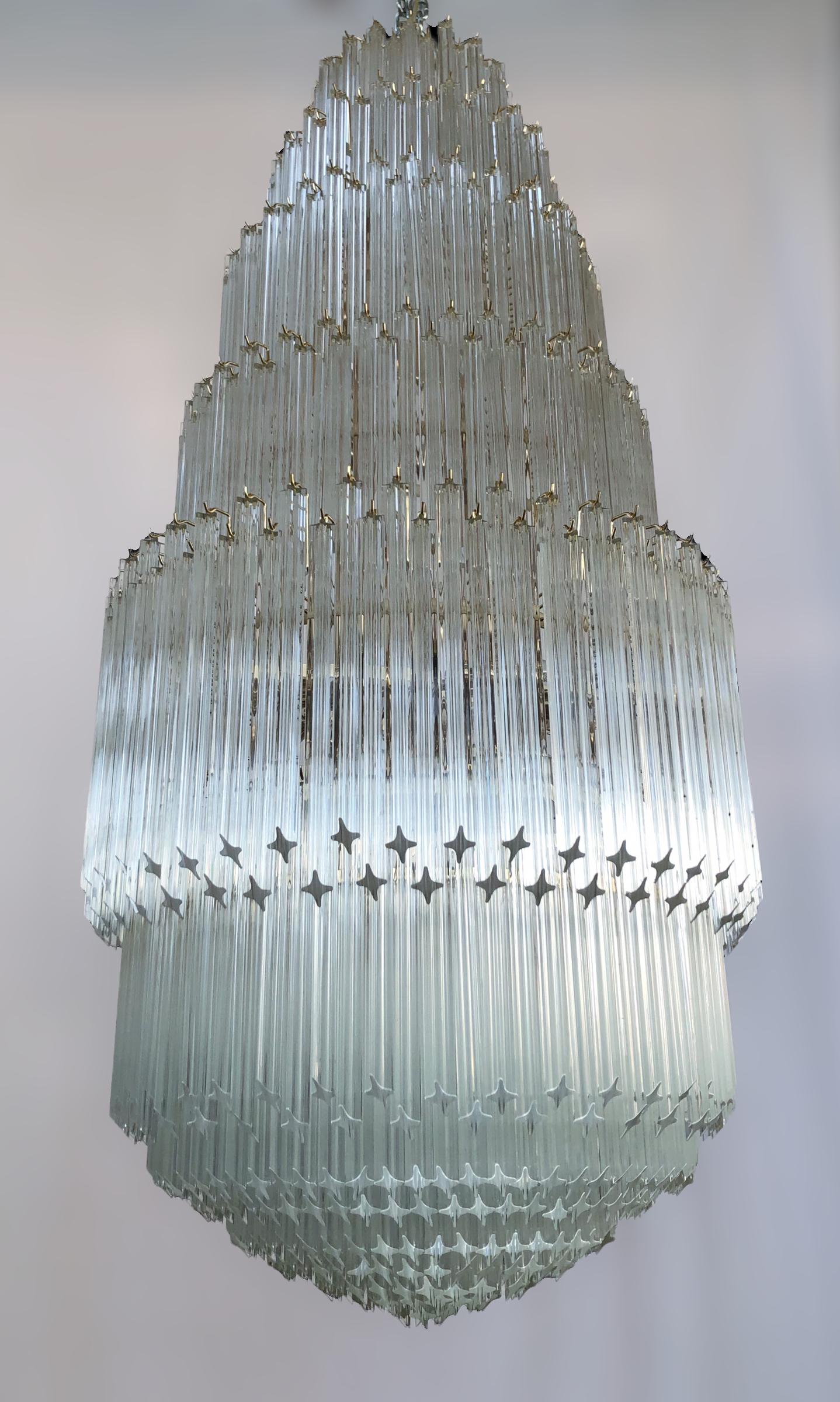 Oversized Italian chandelier shown in six tiers of clear Murano glasses cut into four points using Quadriedri technique, mounted on gold metal finish frame by Fabio Ltd / Made in Italy
32 lights / E26 or E27 type / max 60W each
Measures: diameter
