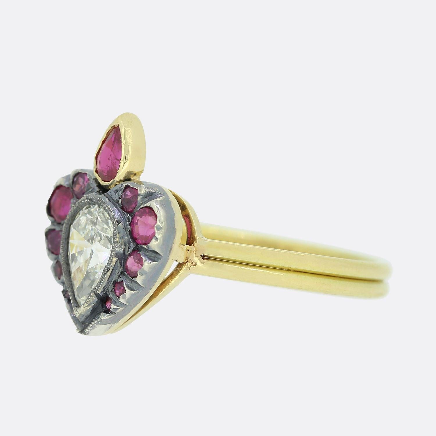 This is a beautiful diamond and ruby ring. The setting of the ring features a wonderful central pear shape diamond surrounded by 11 rubies in a Georgian flaming heart style. The rubies and diamond are set in oxidised silver to emphasise their lovely